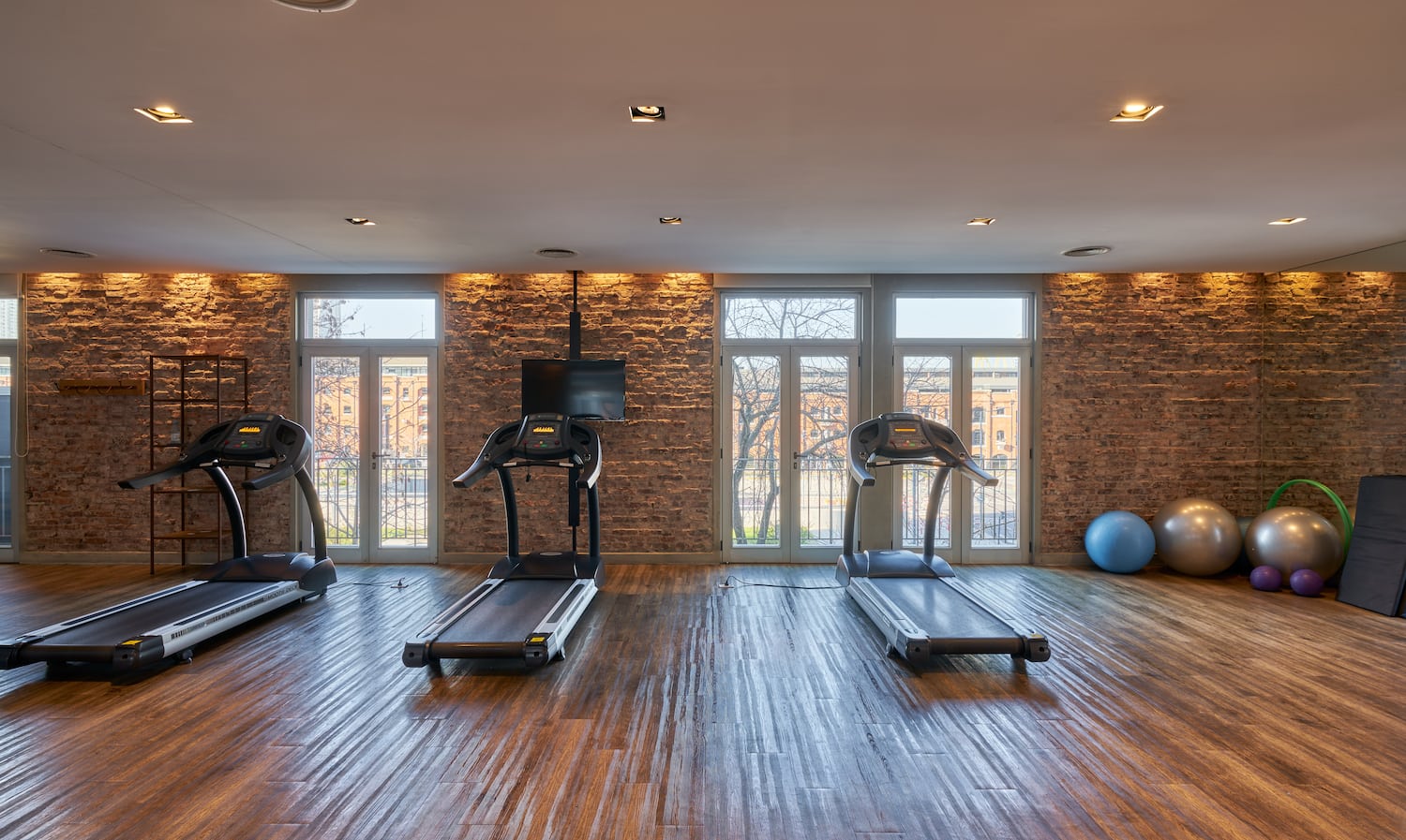 a gym with treadmills and exercise balls
