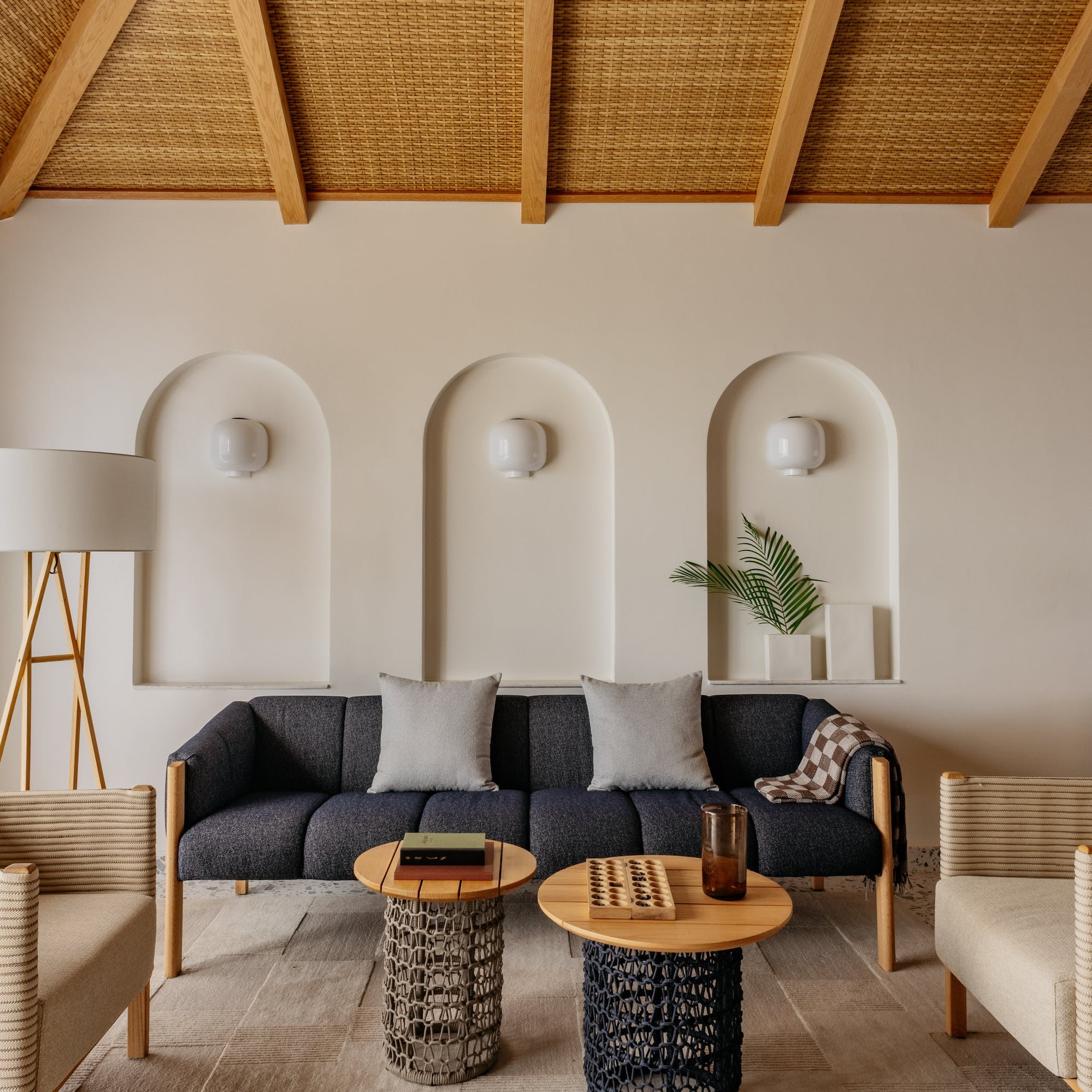 a room with a couch and chairs