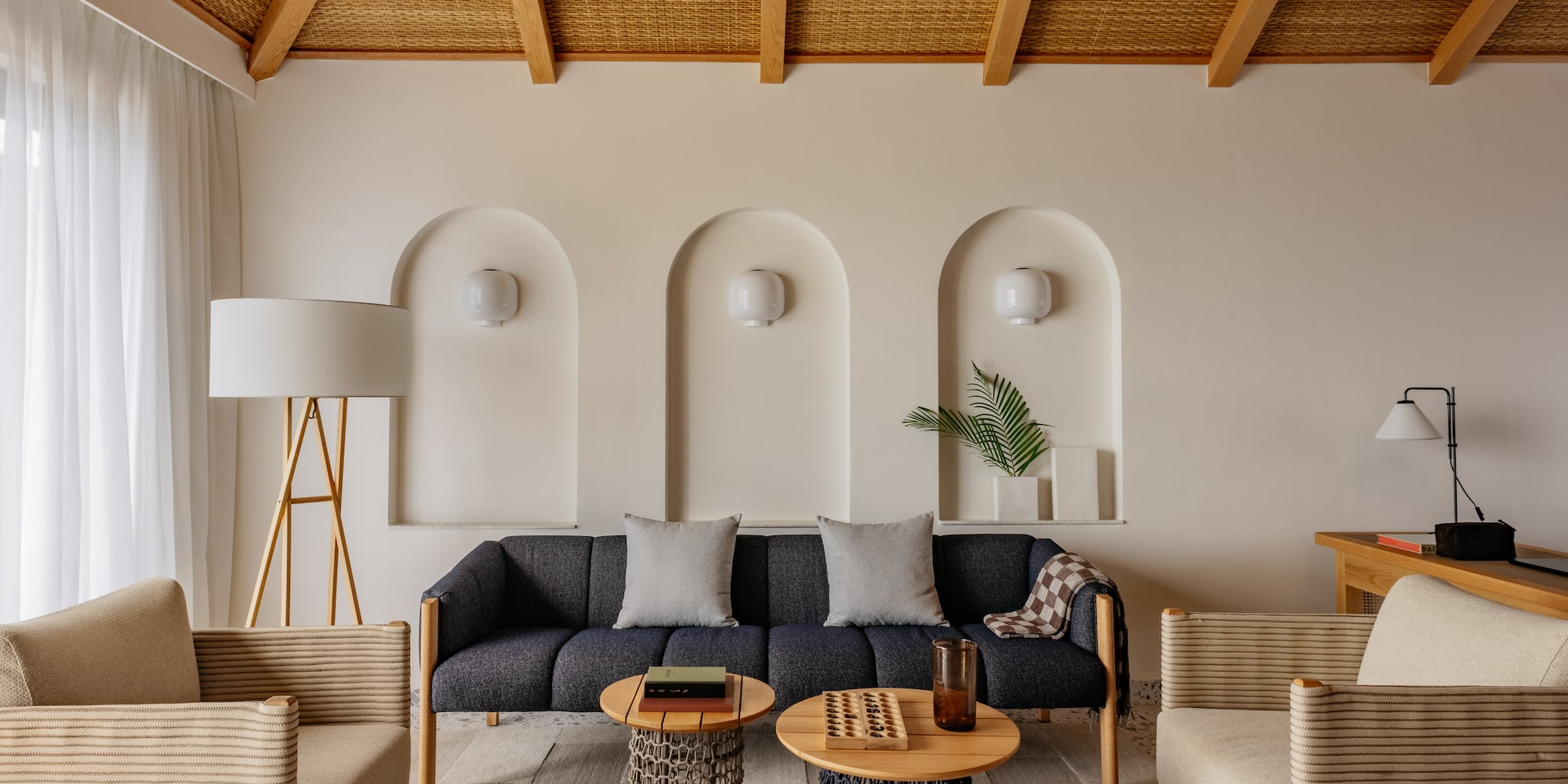 a room with a couch and chairs