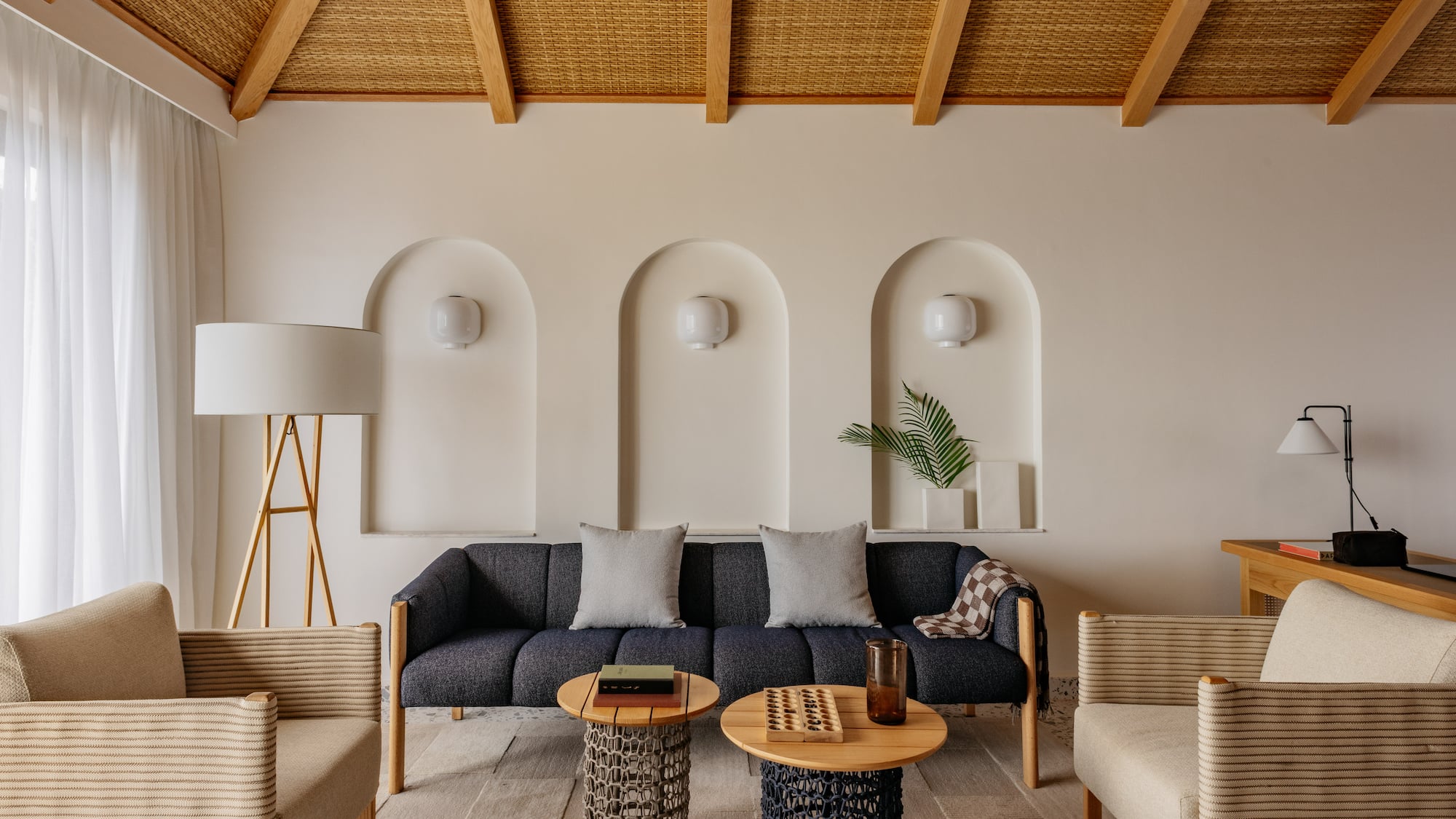 a room with a couch and chairs