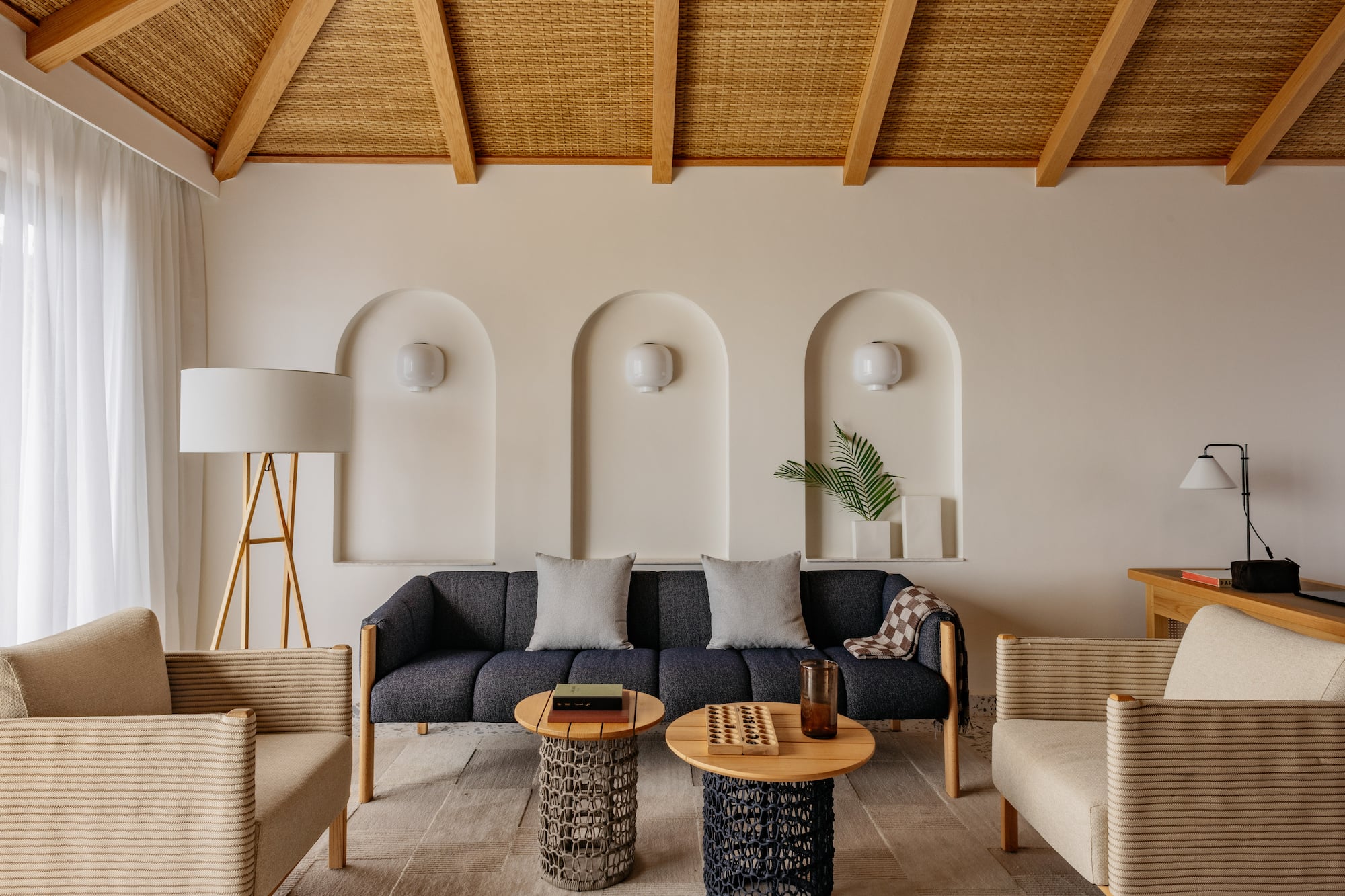 a room with a couch and chairs