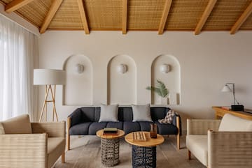 a room with a couch and chairs