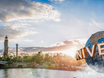 a large fountain with a large sign in front of a water body