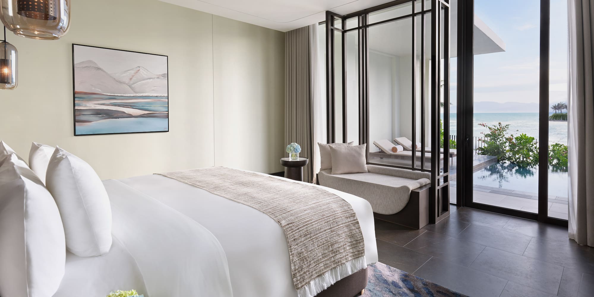 a bedroom with a view of the ocean