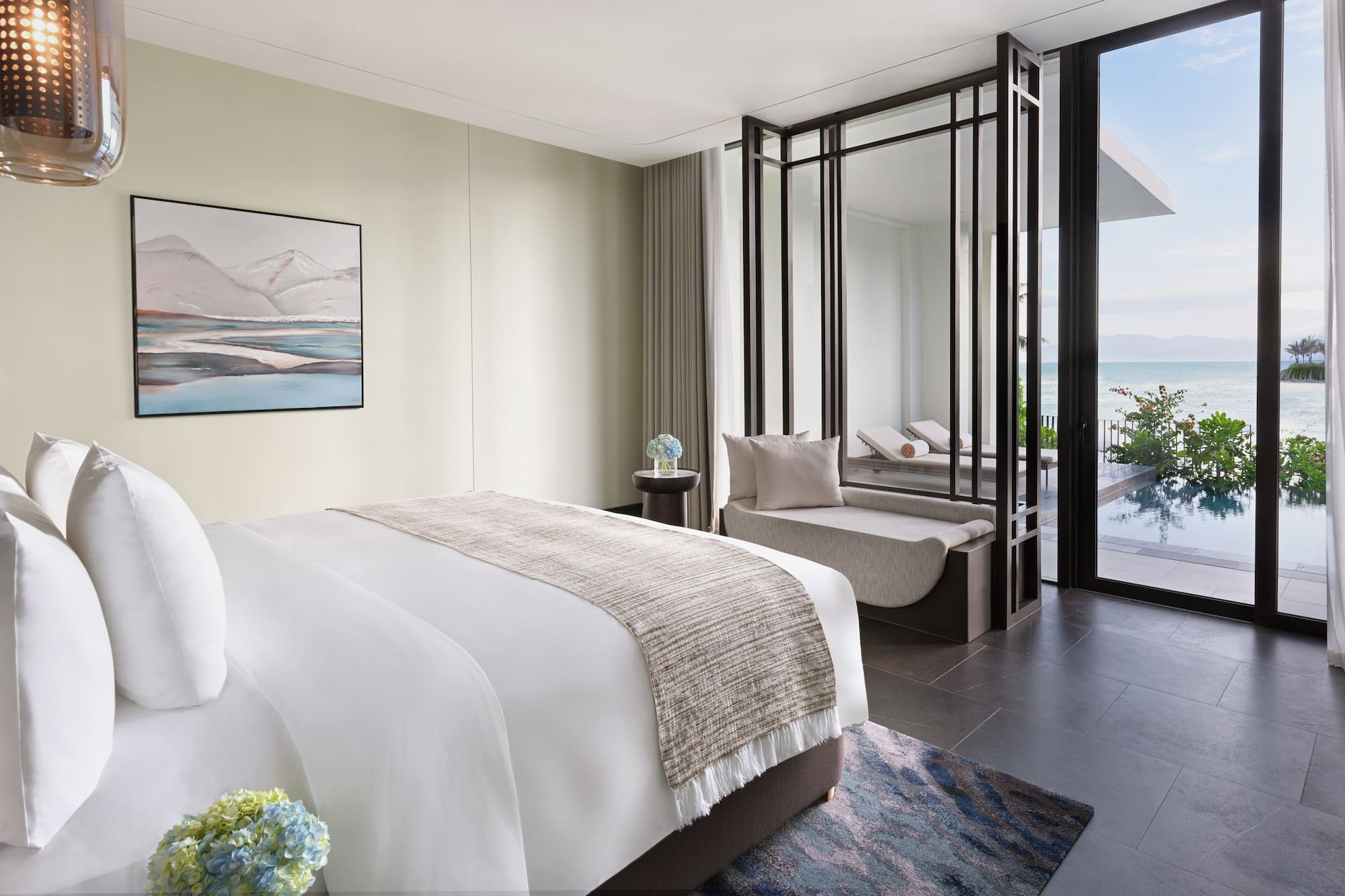 a bedroom with a view of the ocean