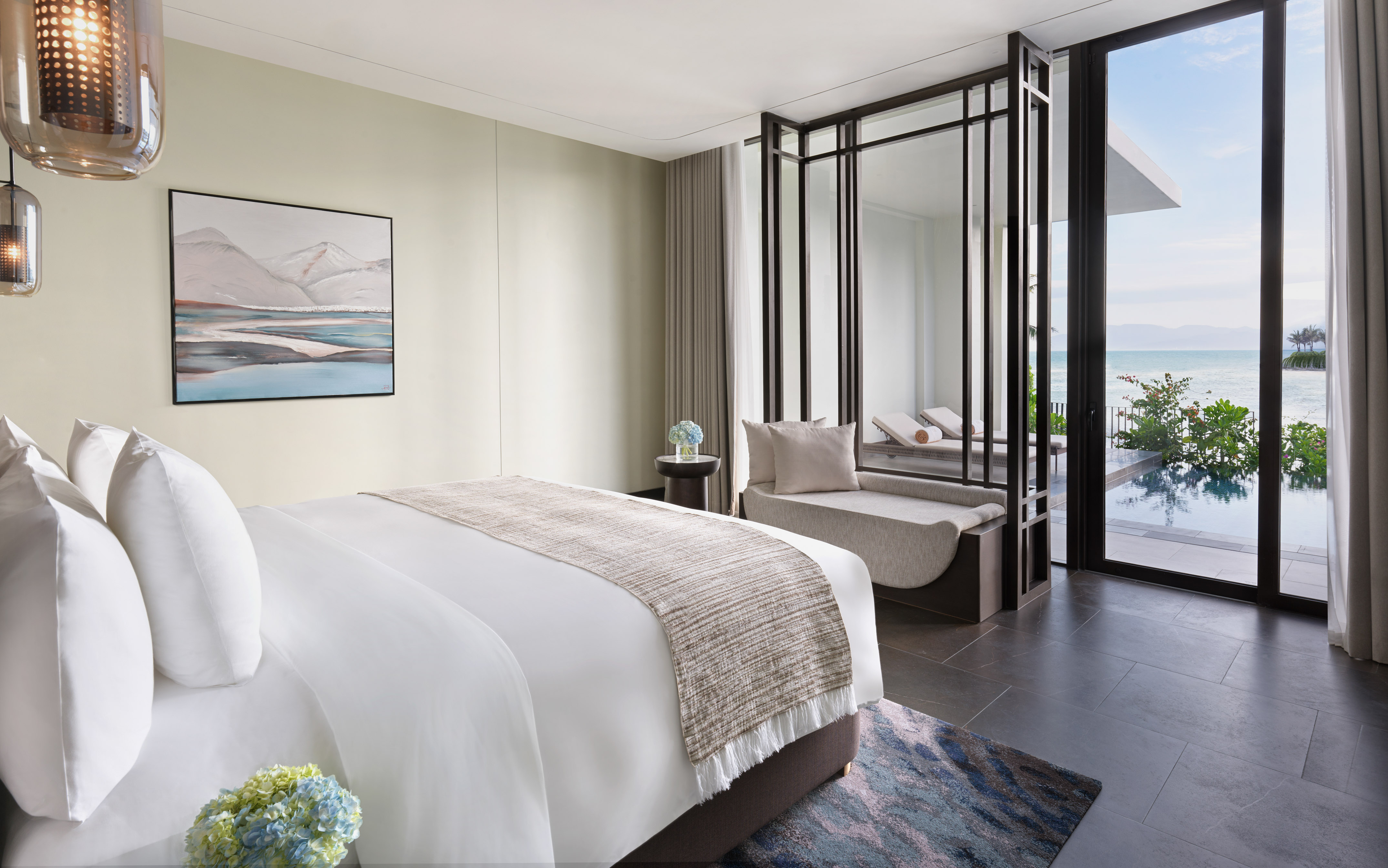 Luxury hotel room with ocean view, private pool, king bed, and modern design.