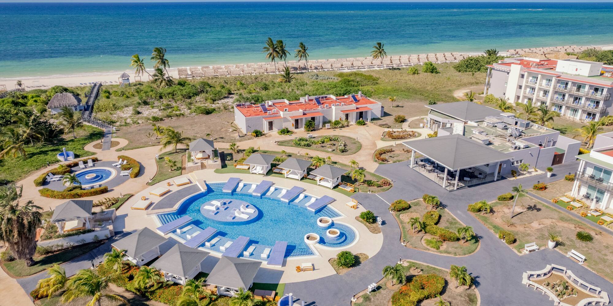a resort with a pool and a beach