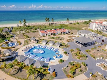 a resort with a pool and a beach