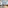 Modern studio apartment with living area, sofa, and separated bedroom.