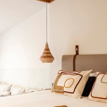 a bed with pillows and a lamp