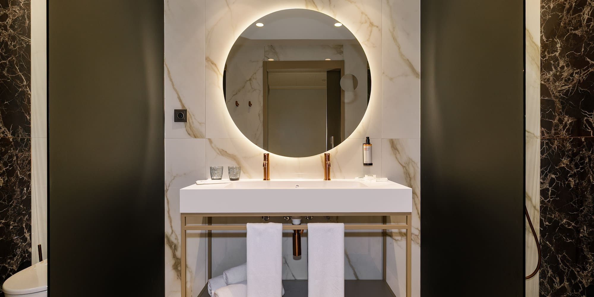 a bathroom with a round mirror