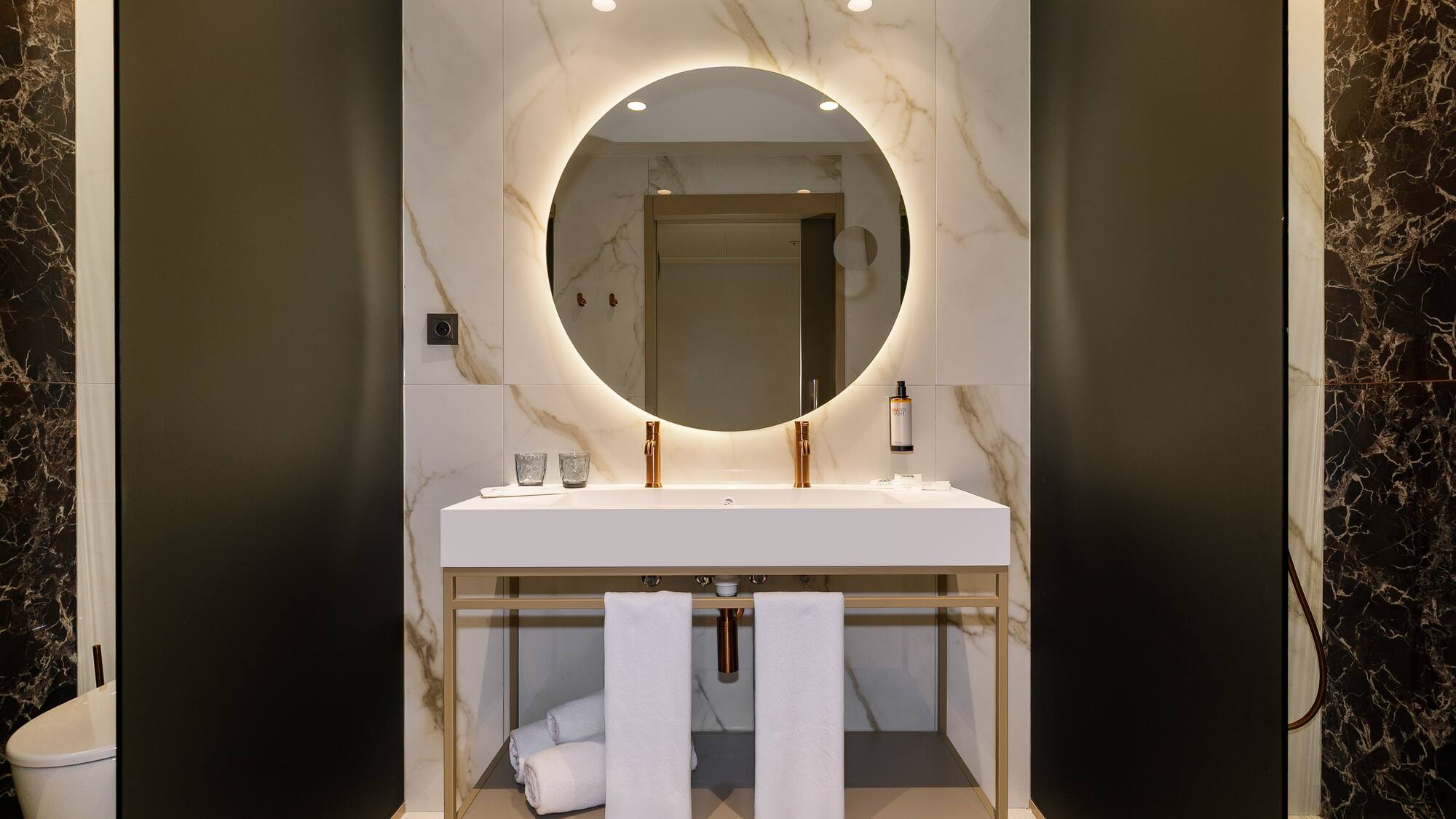 a bathroom with a round mirror