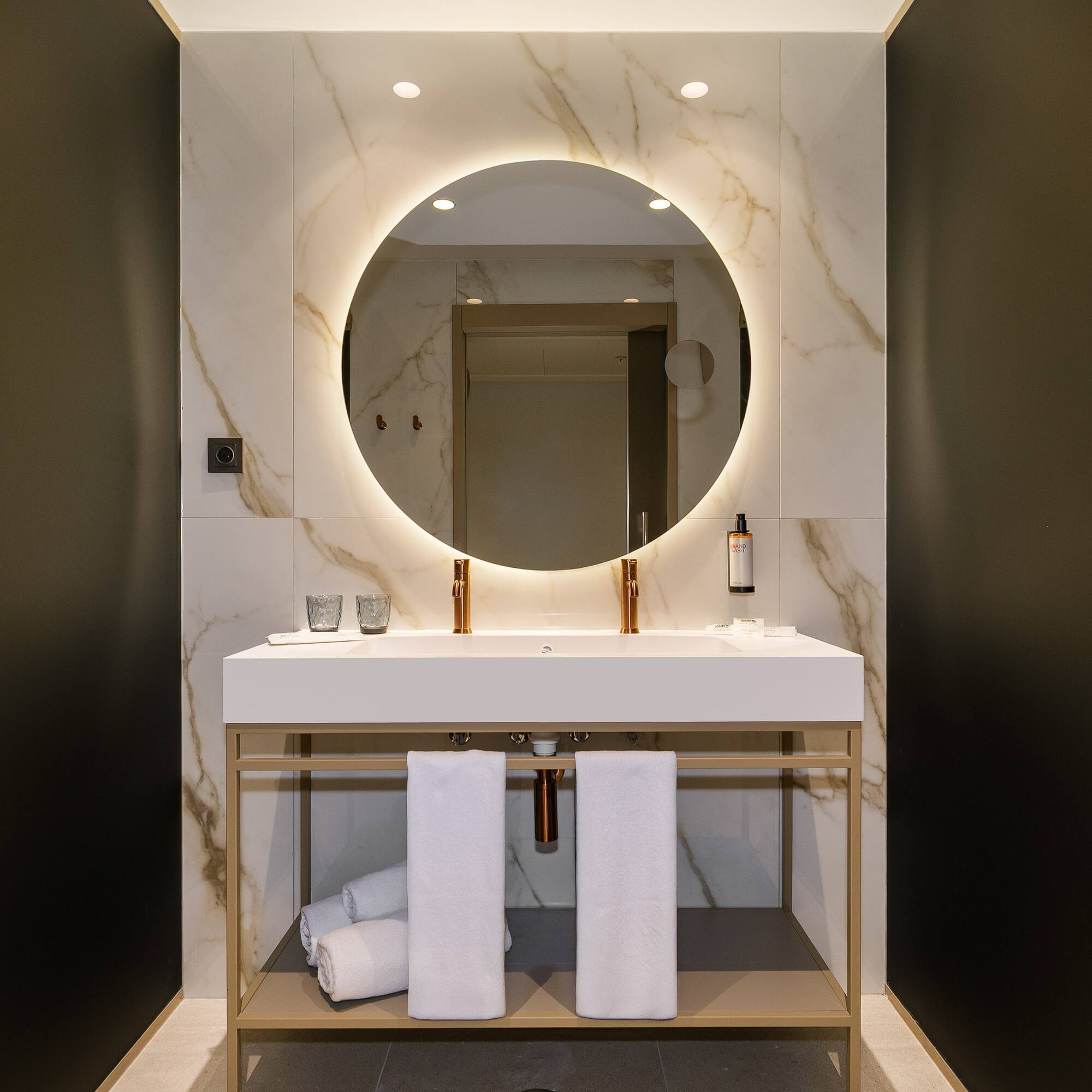 a bathroom with a round mirror