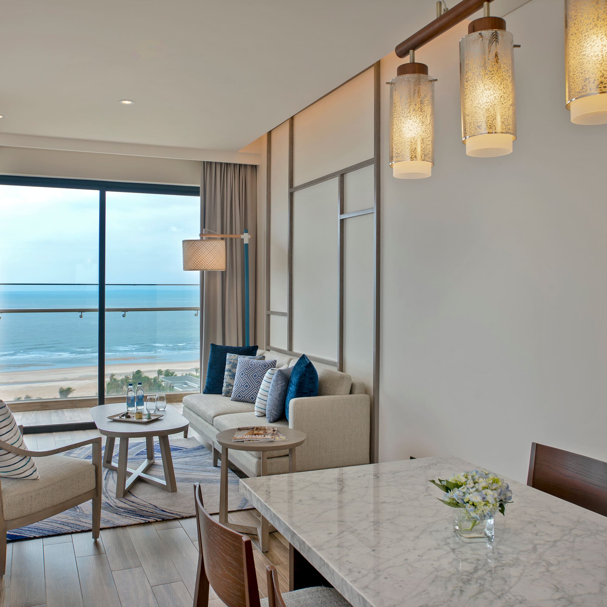 a room with a table and chairs and a large window