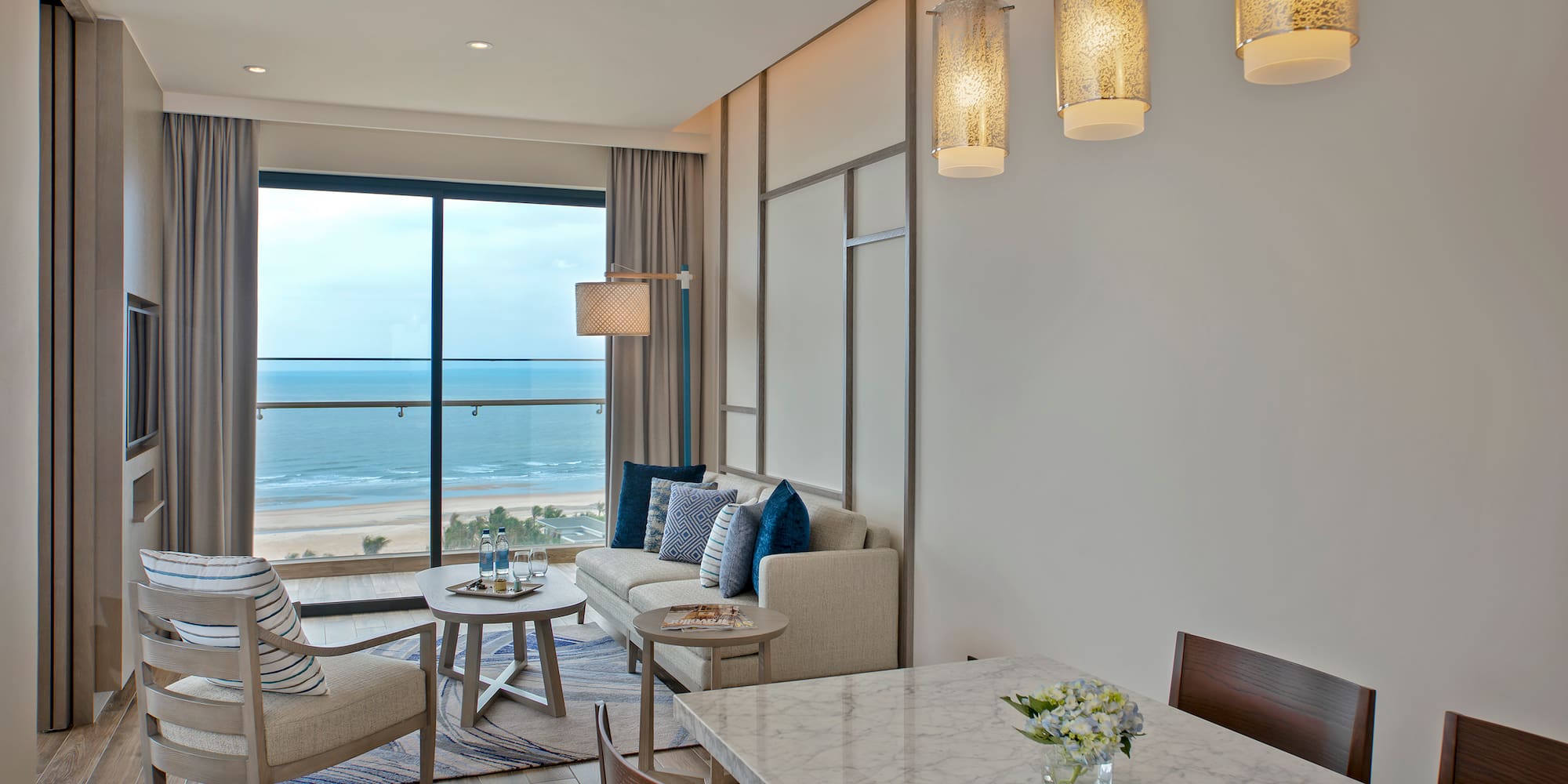 a room with a table and chairs and a large window