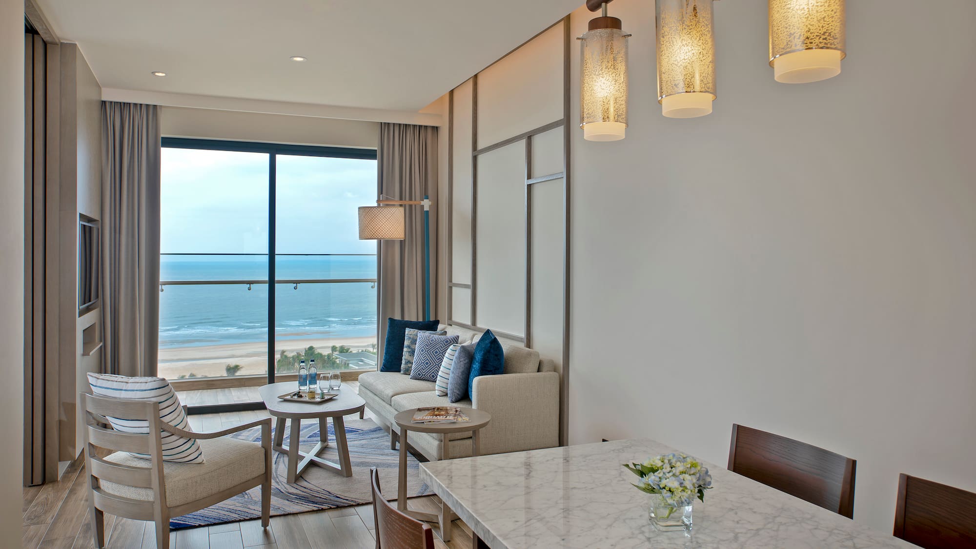 a room with a table and chairs and a large window