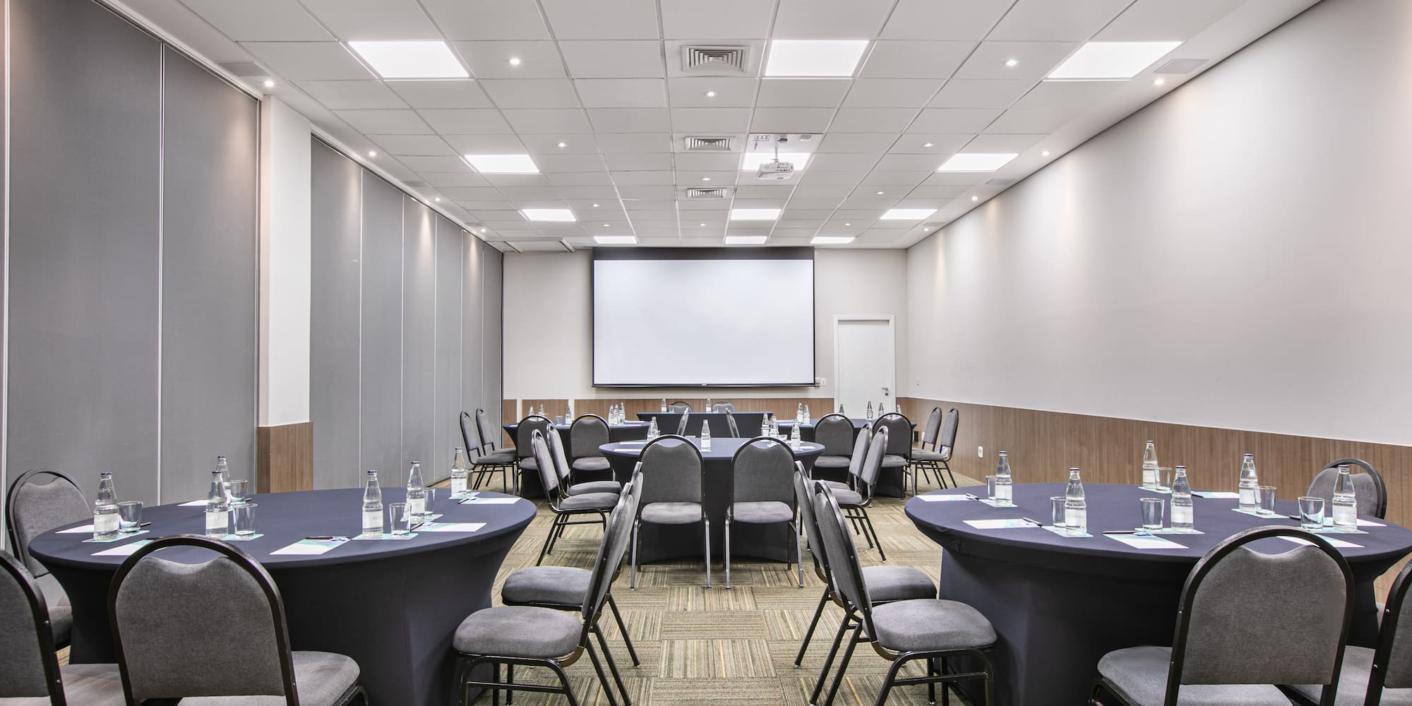 a room with round tables and chairs