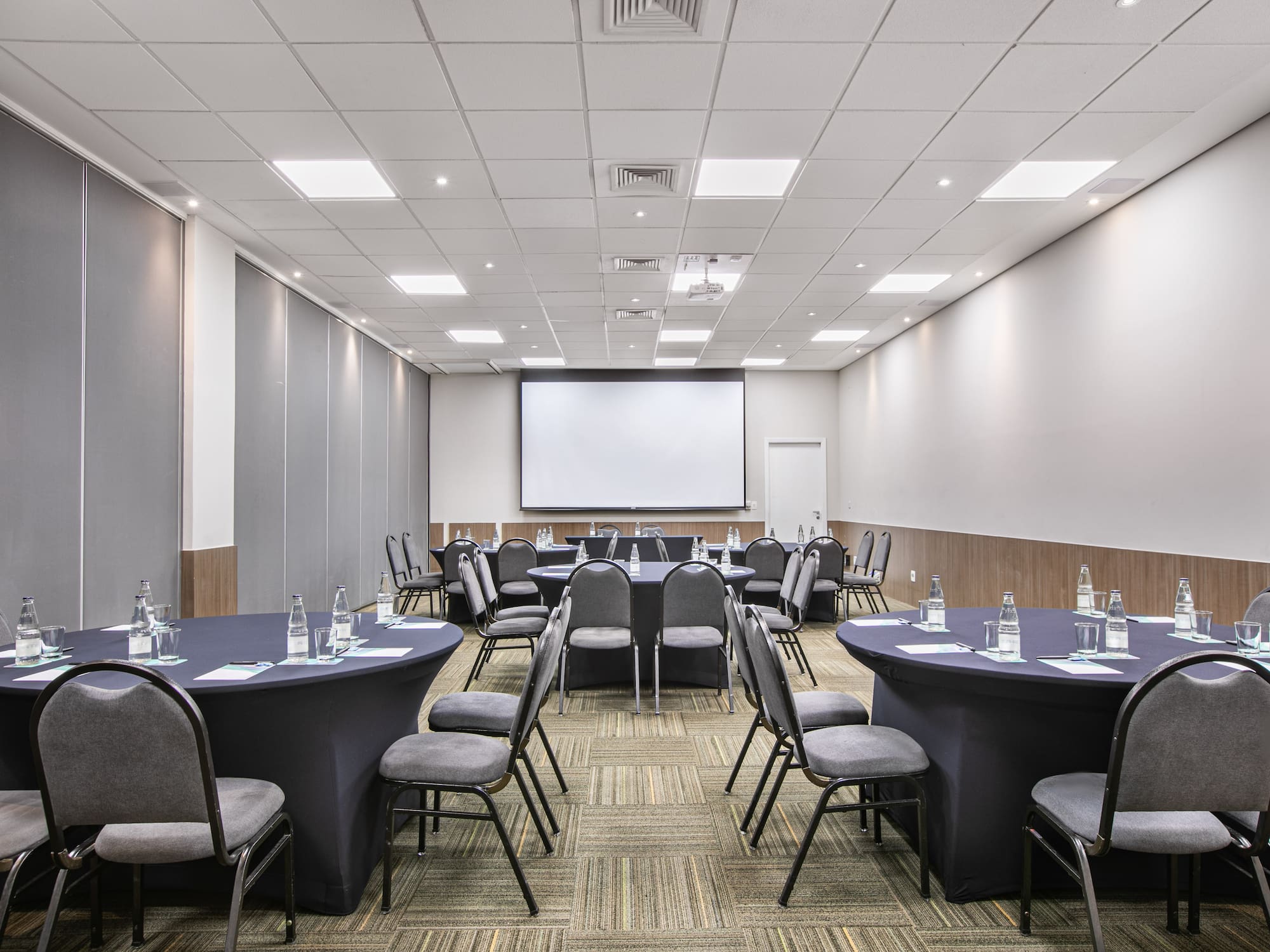 a room with round tables and chairs