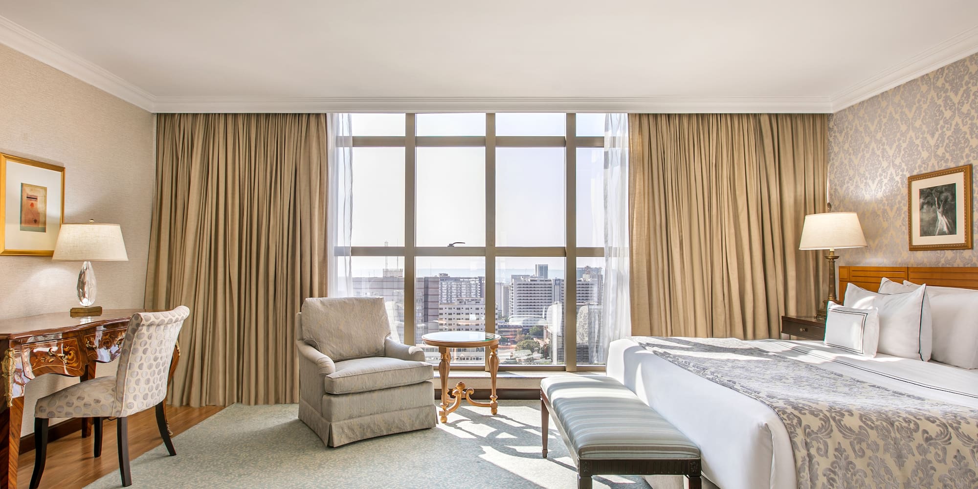 a room with a bed and chairs and a table