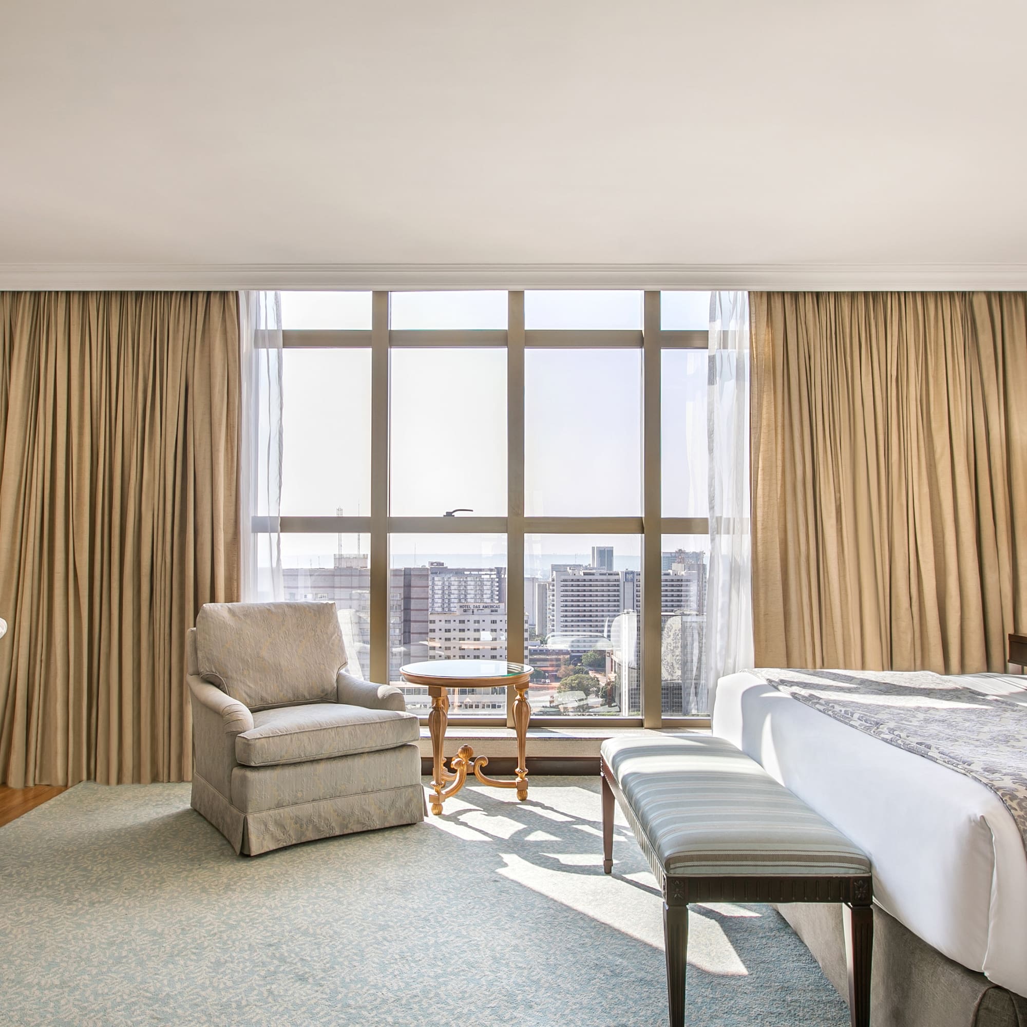 a room with a bed and chairs and a table