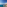 Panoramic view of coastal resort, blue ocean, sandy beach, and palm trees.