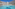 Sunny resort hotel with large swimming pool, palm trees, and lounge area.
