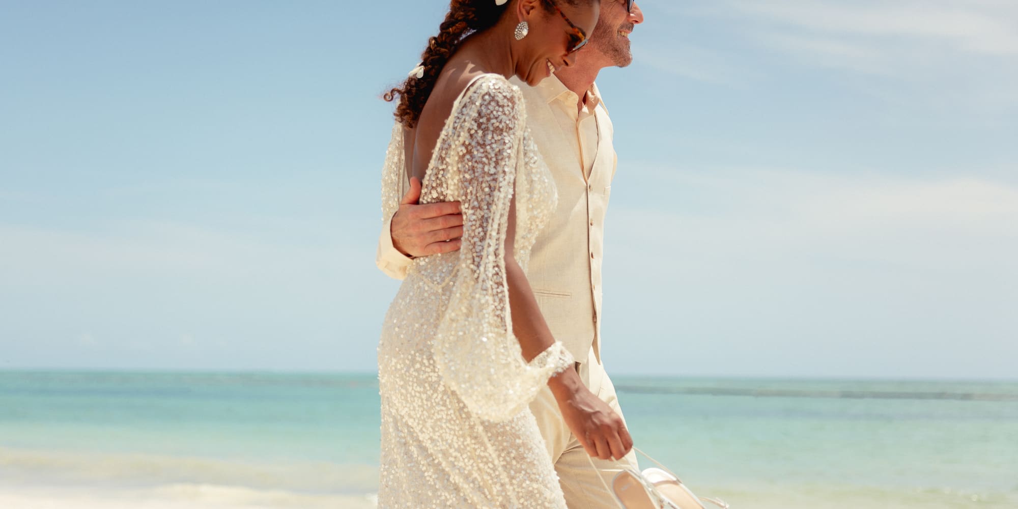 a man and woman walking on a beach