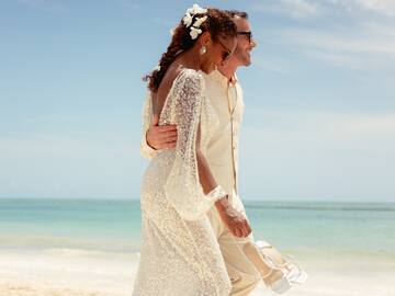 a man and woman walking on a beach