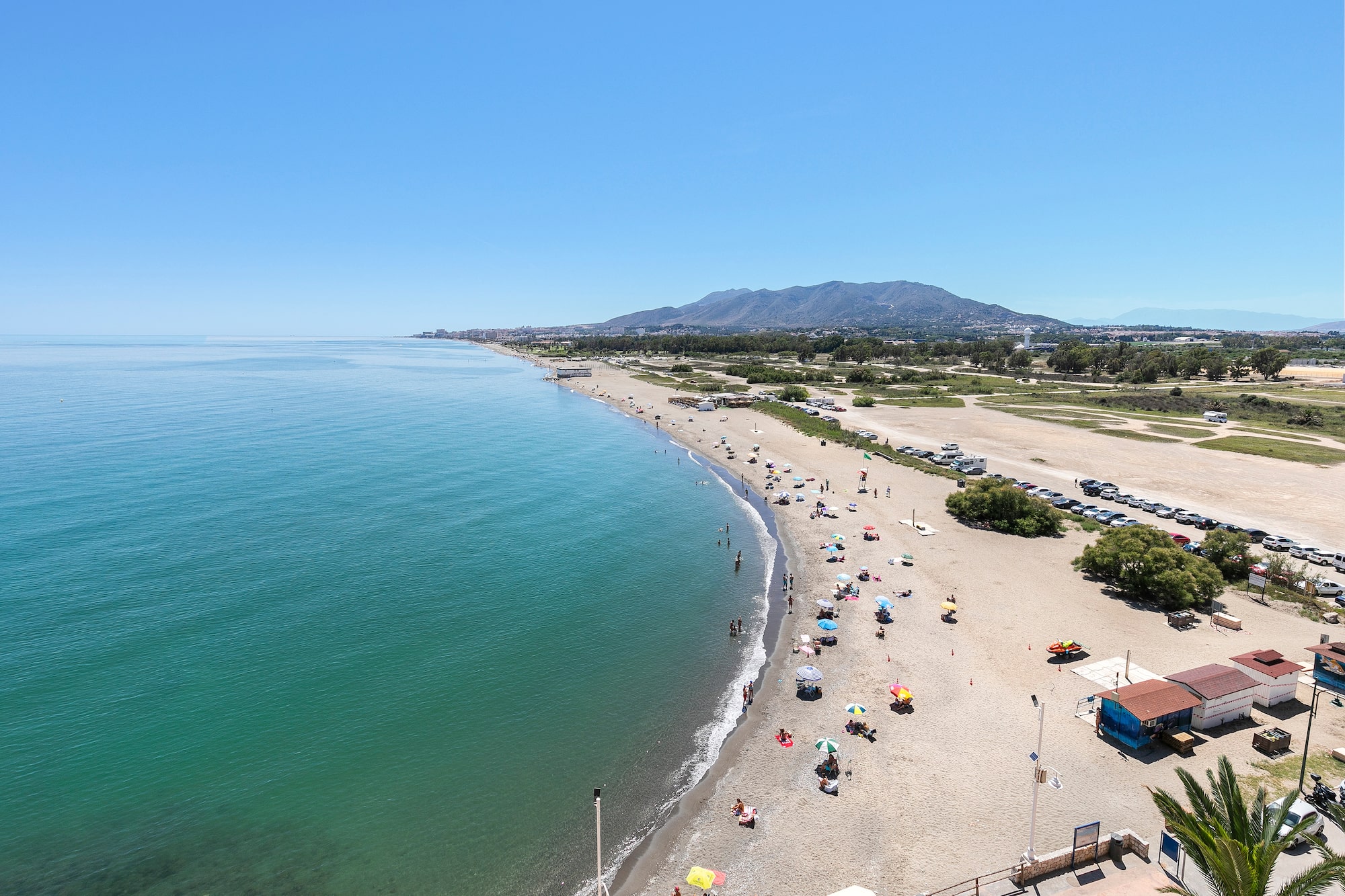 a beach with many umbrellas and people on it