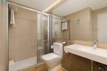 a bathroom with a shower and toilet