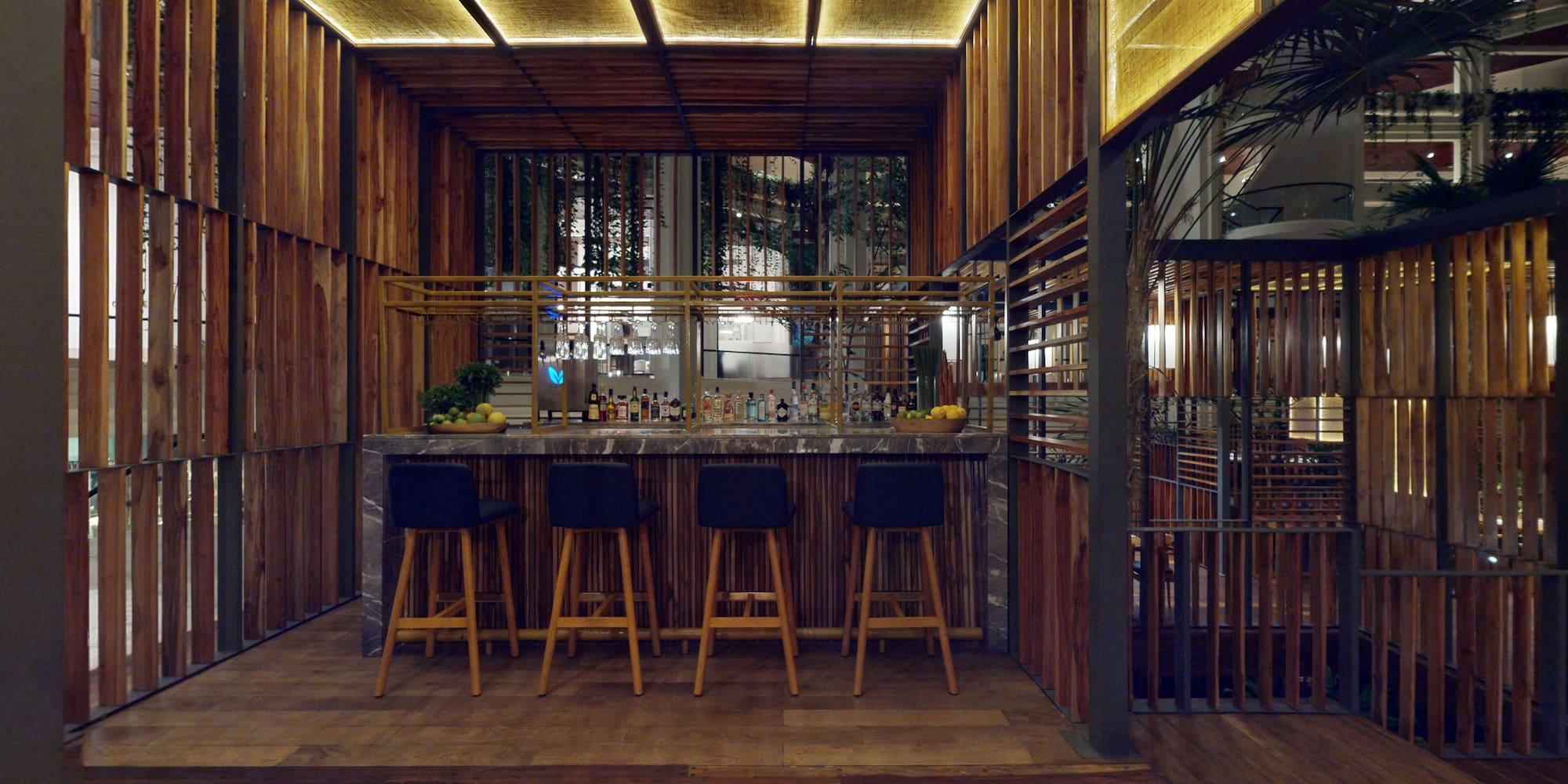 a bar with stools and a bar in a room