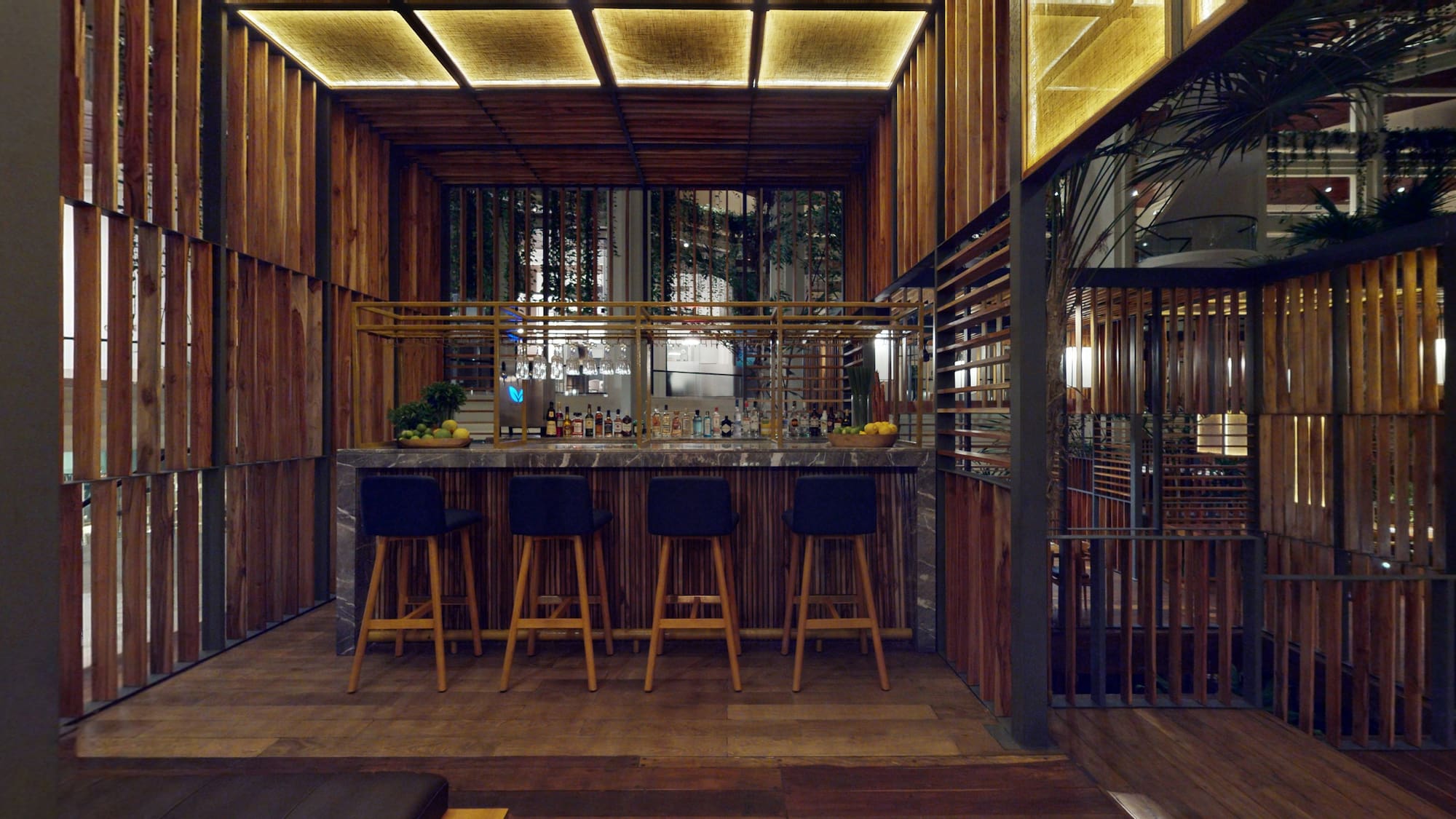 a bar with stools and a bar in a room
