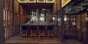 a bar with stools and a bar in a room