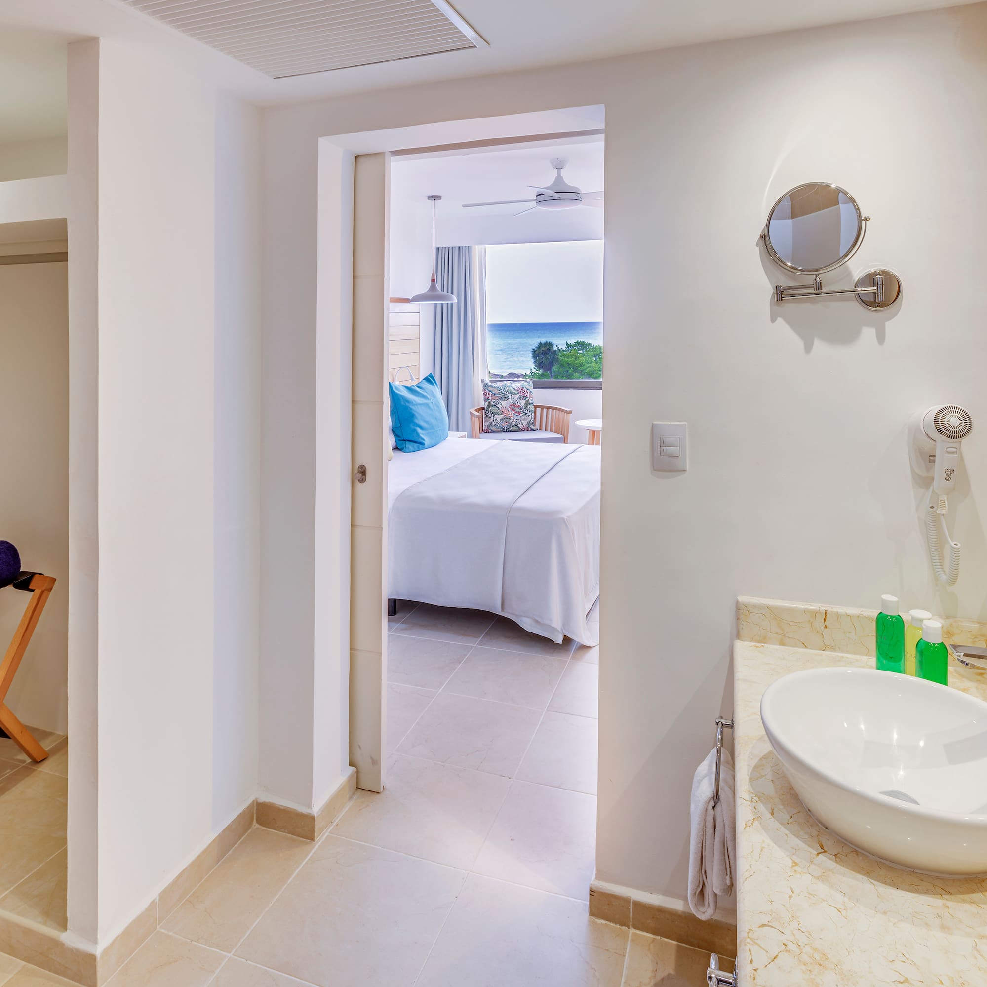 a bathroom with a bed and a mirror