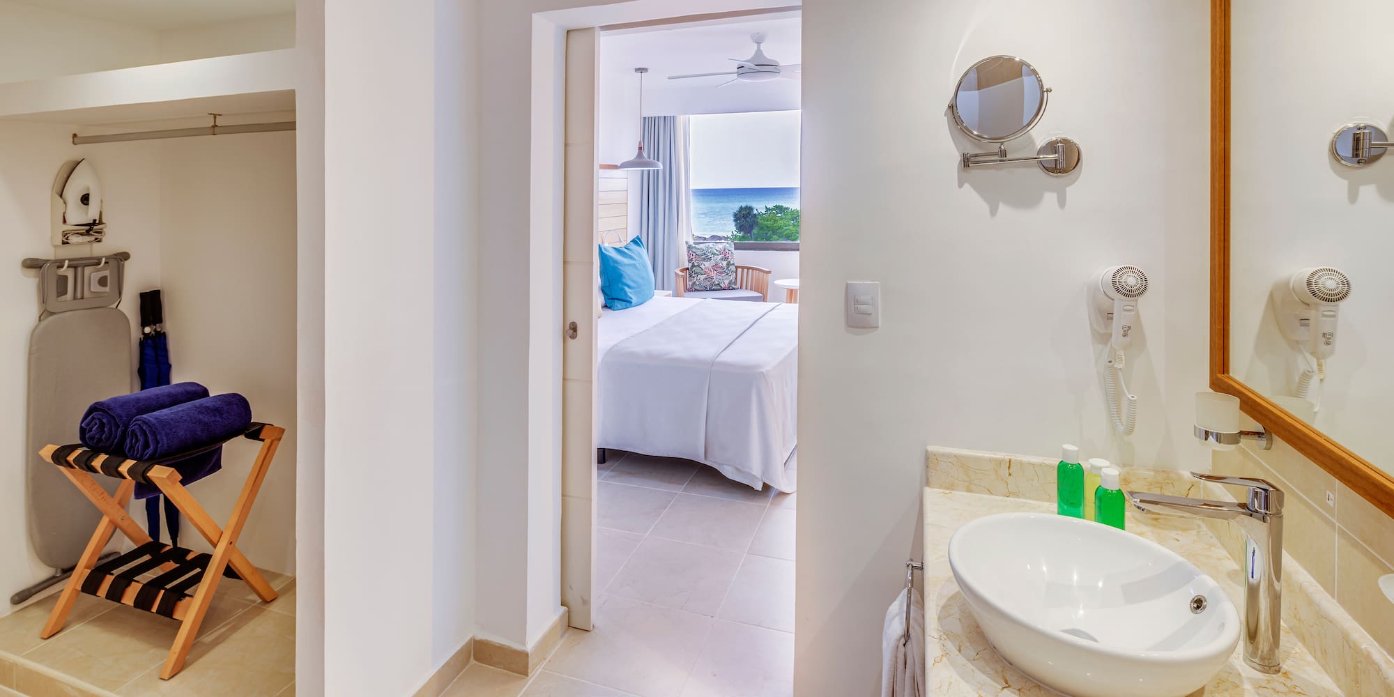 a bathroom with a bed and a mirror