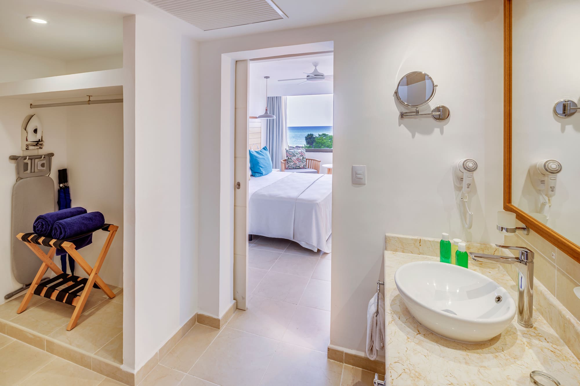 a bathroom with a bed and a mirror