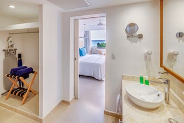 a bathroom with a bed and a mirror