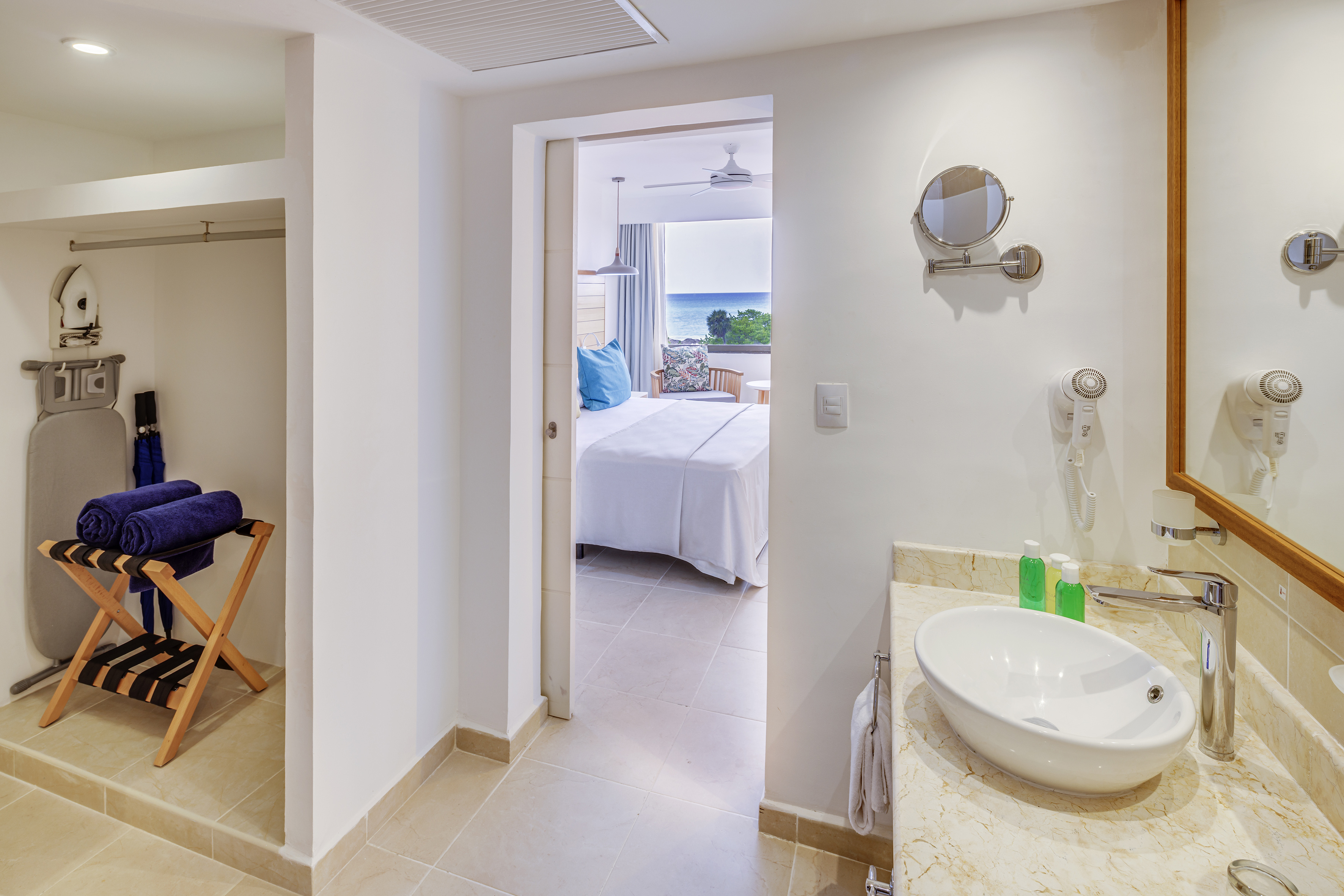 a bathroom with a bed and a mirror