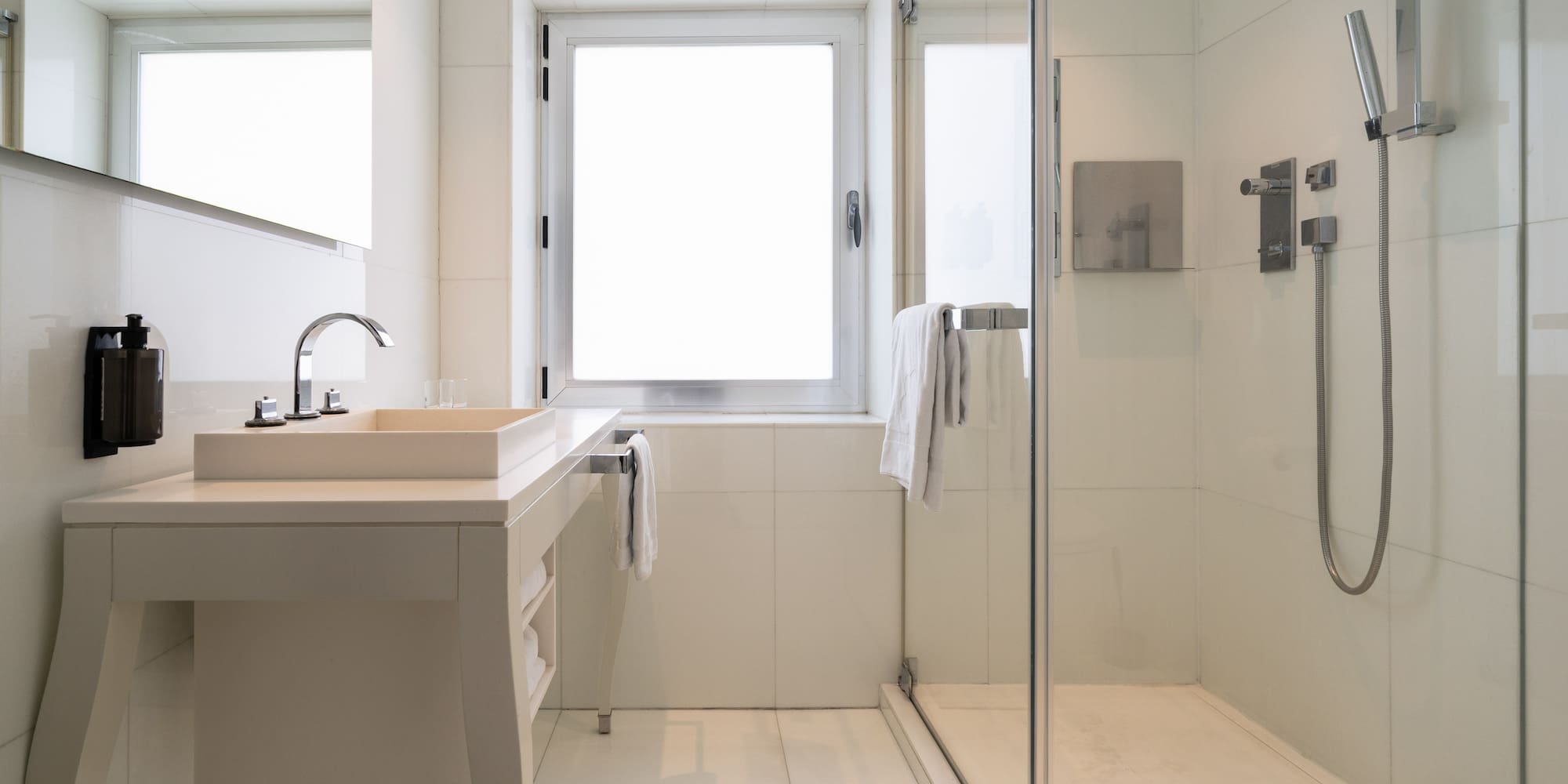 a bathroom with a glass shower and sink