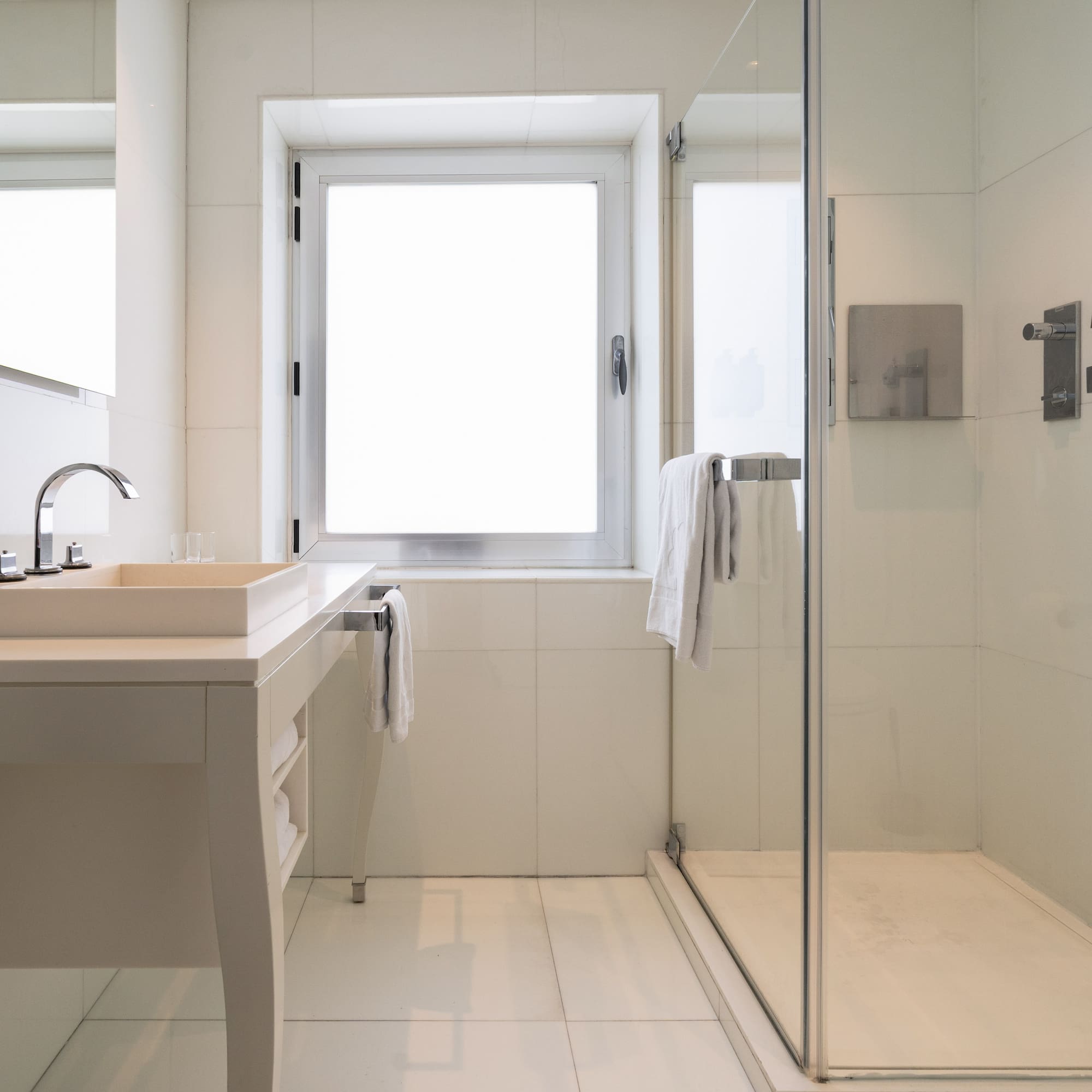 a bathroom with a glass shower and sink