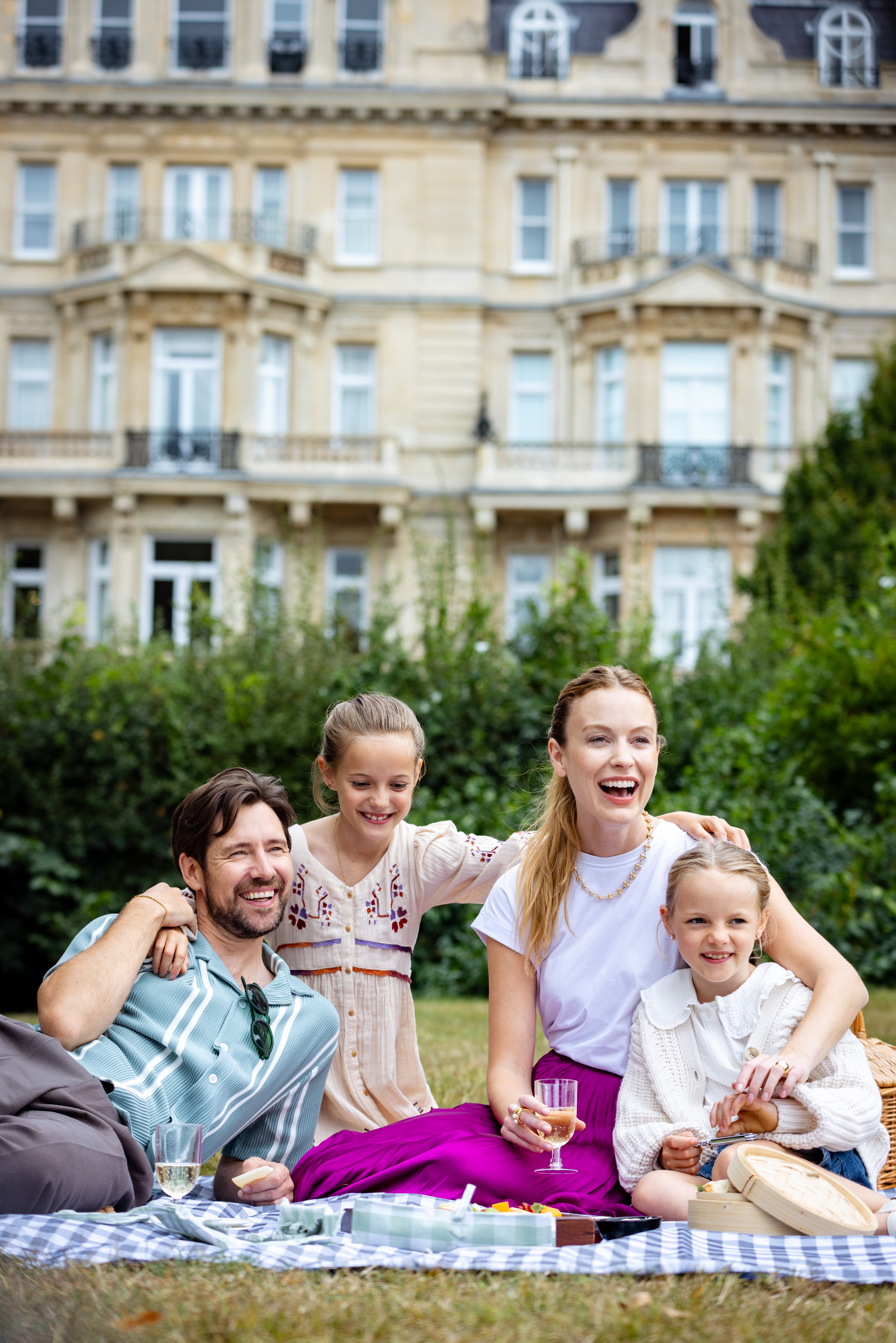 a group of people sitting on a picnic basket