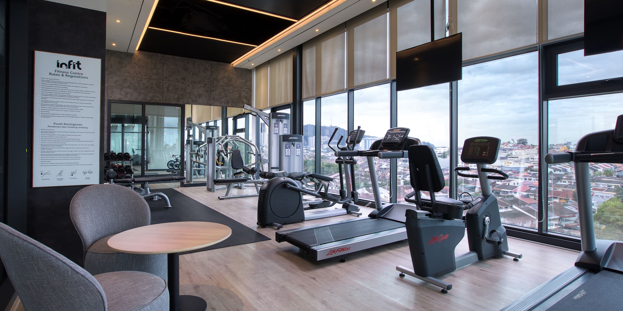 a room with exercise equipment and a large window