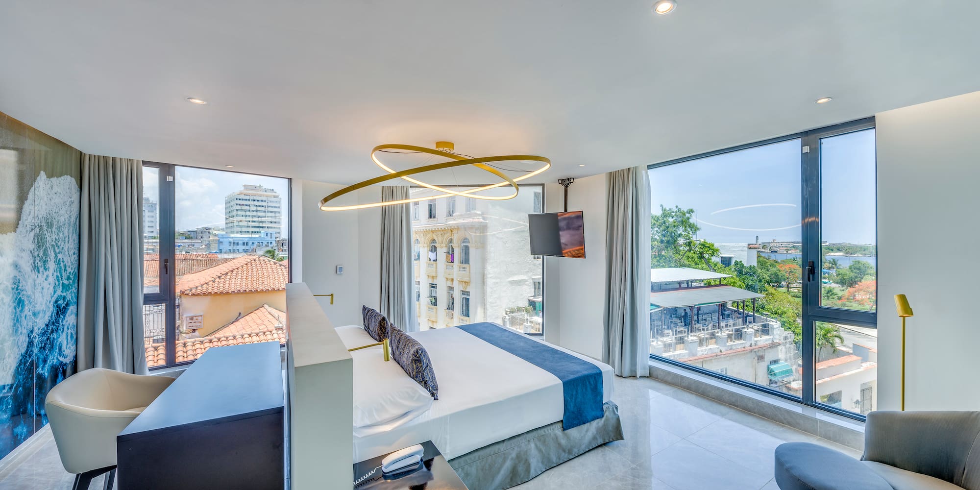 a bedroom with a large bed and a television