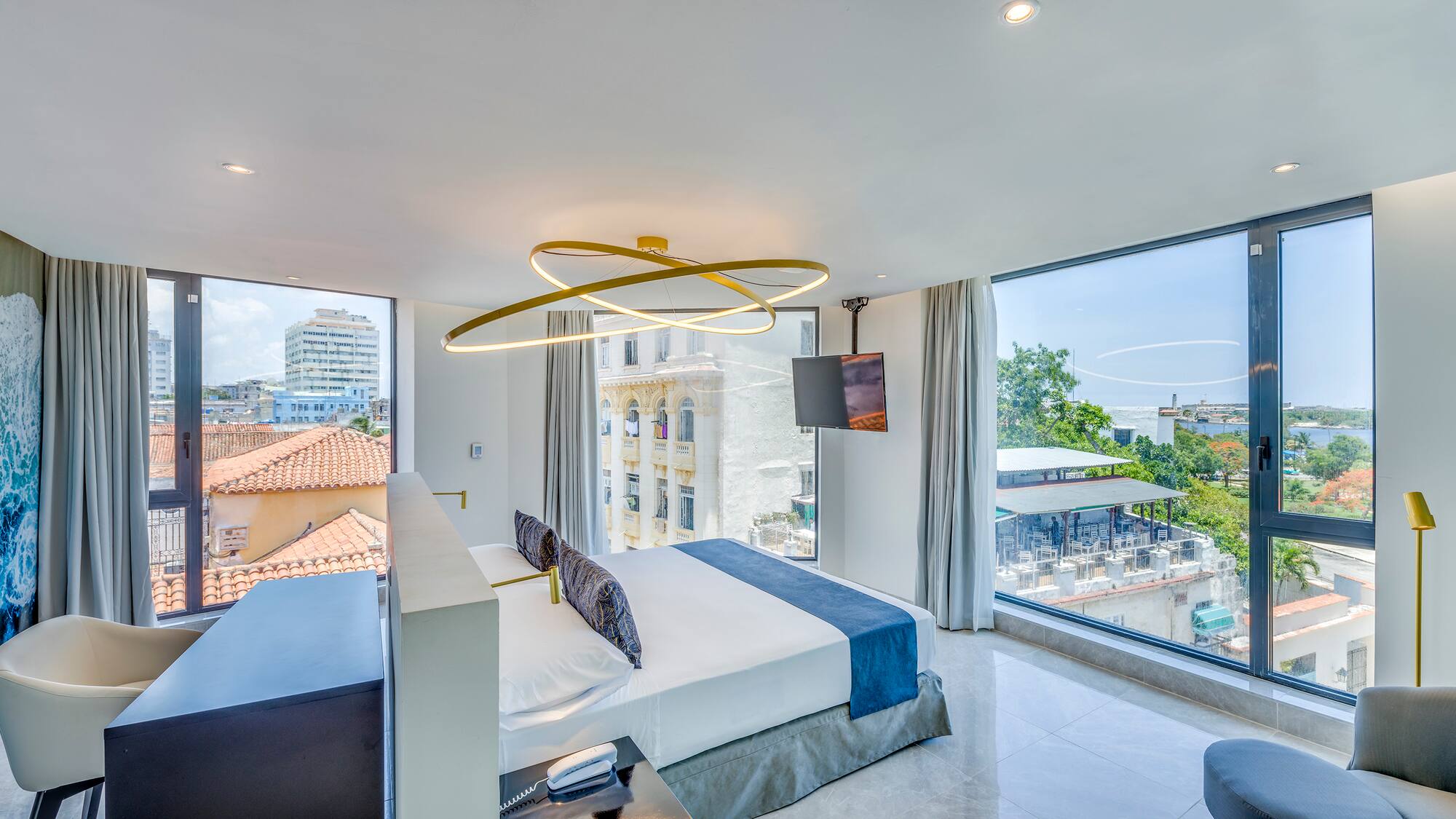 a bedroom with a large bed and a television