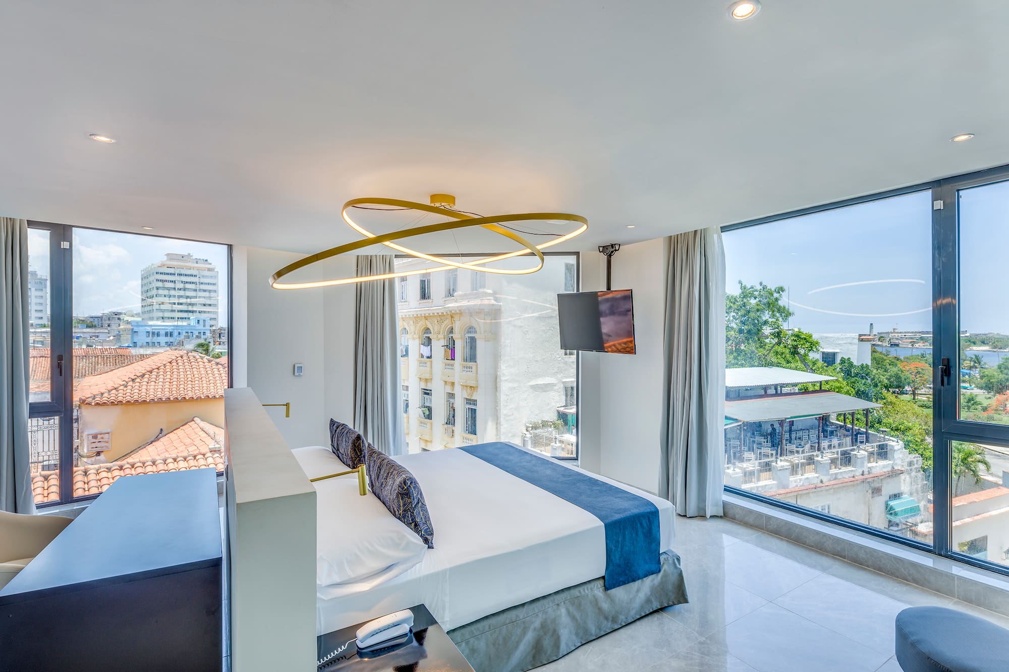 a bedroom with a large bed and a television