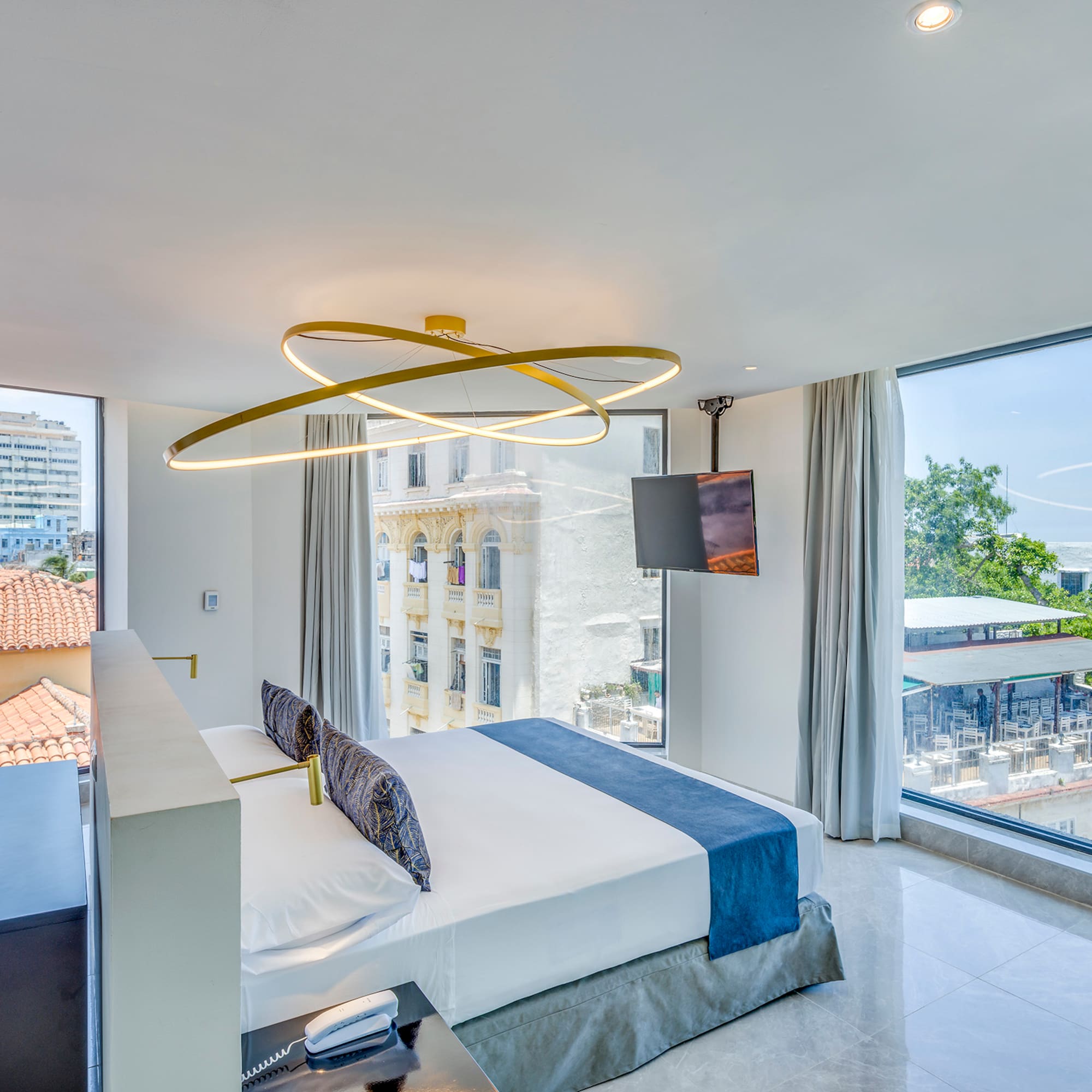 a bedroom with a large bed and a television