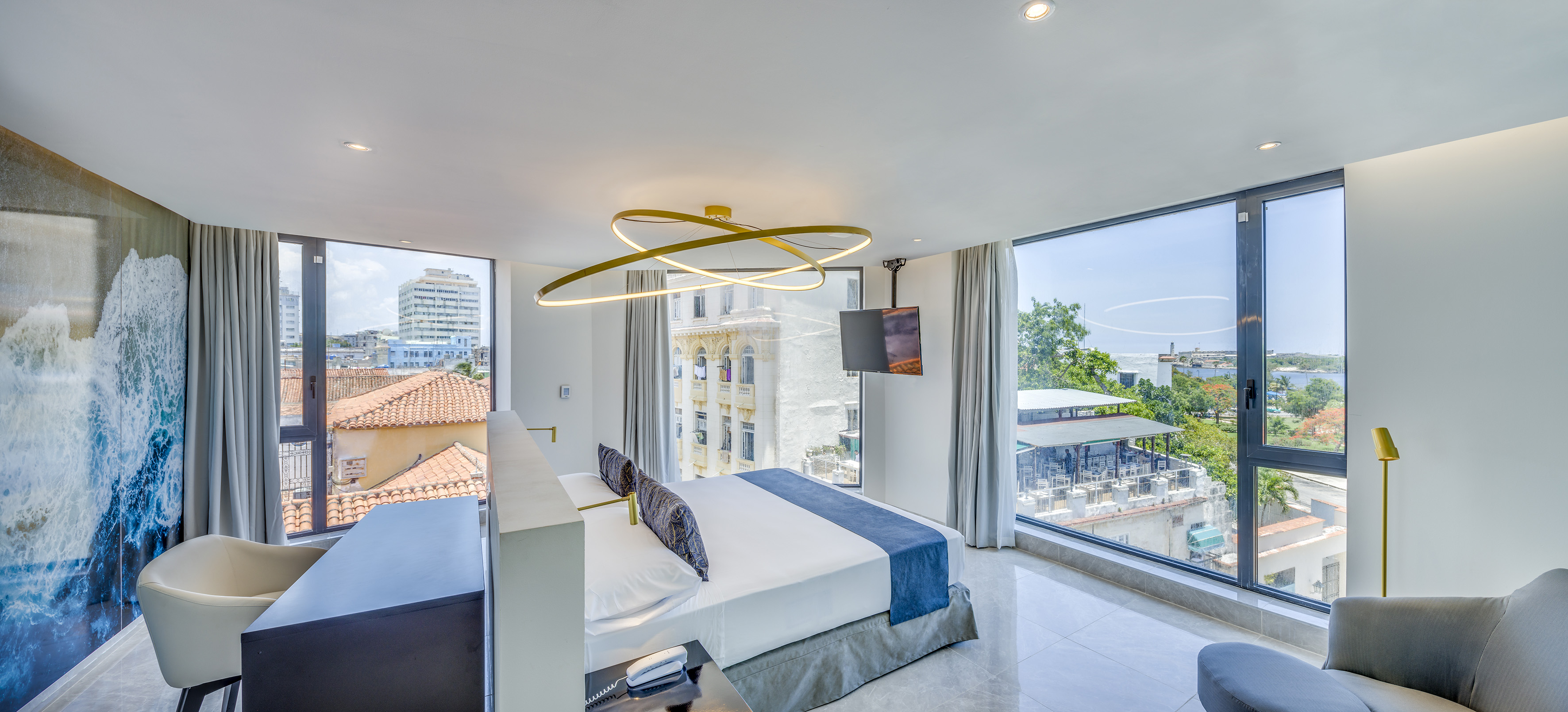 a bedroom with a large bed and a television