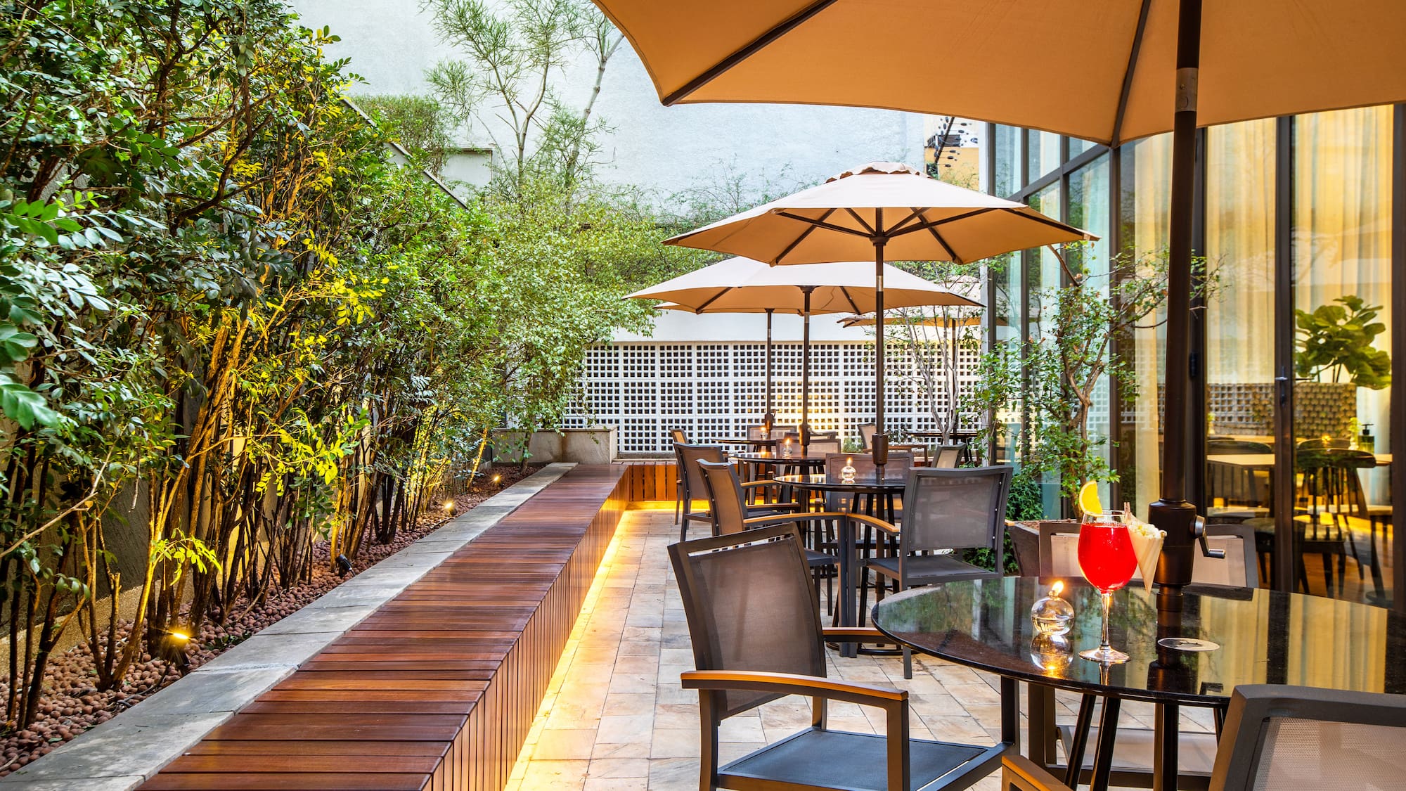 a patio with tables and umbrellas