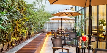 a patio with tables and umbrellas