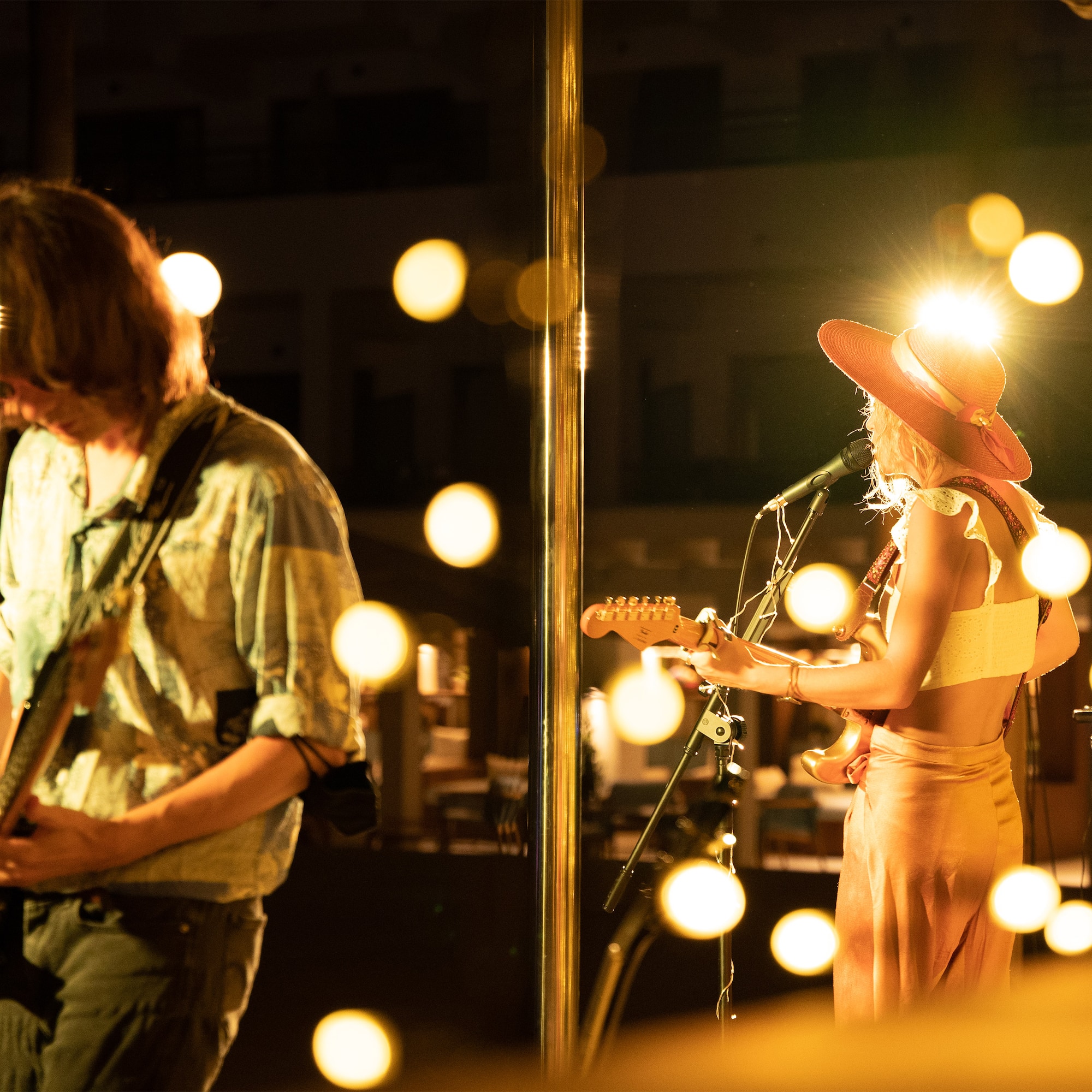 a woman playing guitar and a man playing a guitar
